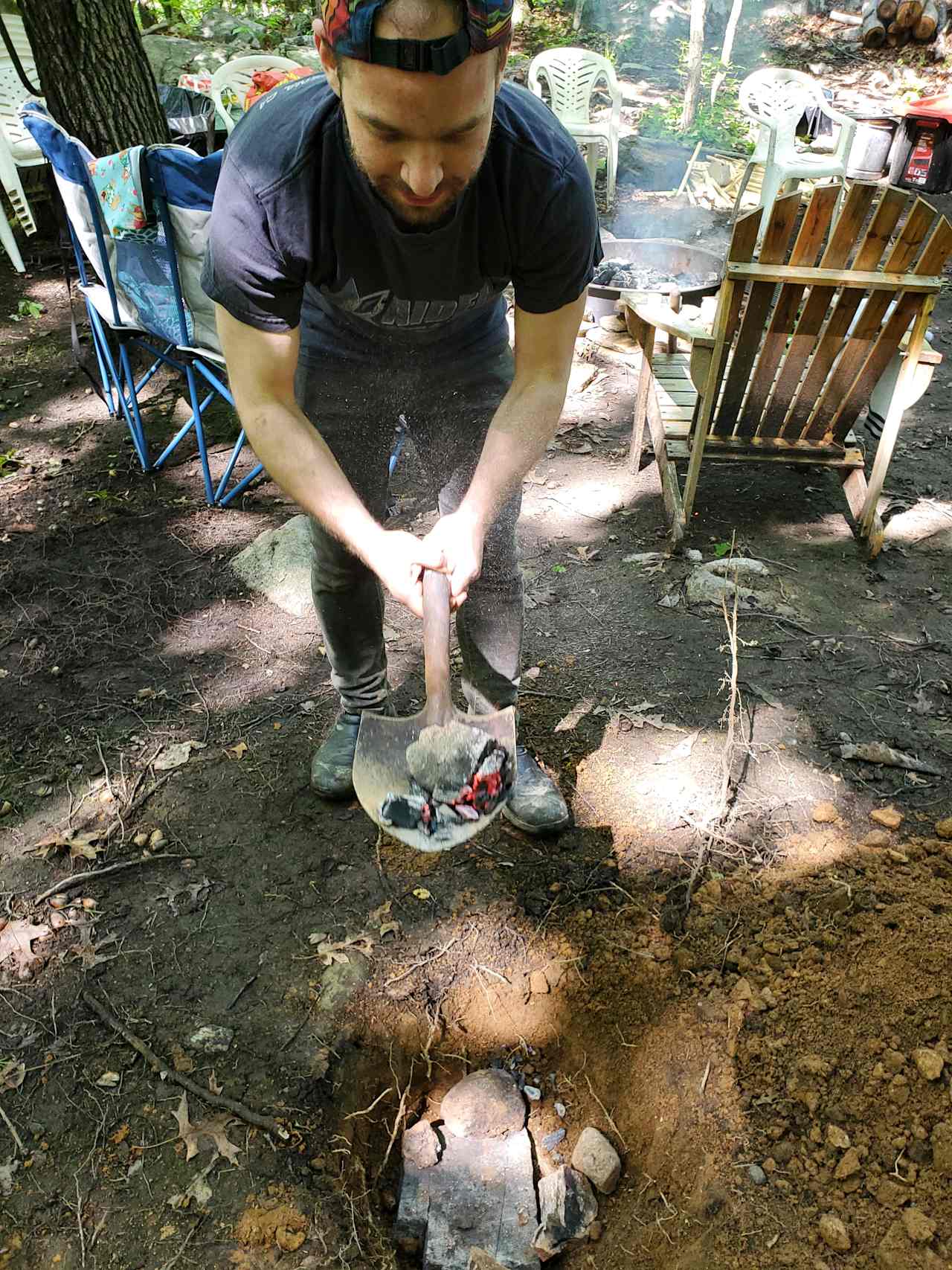 Dig a hole and fill it with hot rocks from the campfire, then place your well wrapped roast.  In this case we wrapped the pernil with banana leaves and foil.