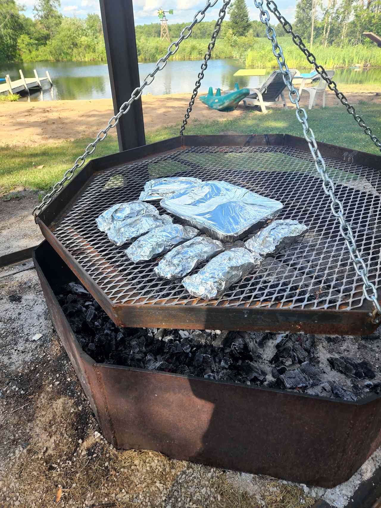 grate can be lowered to cook over an open fire