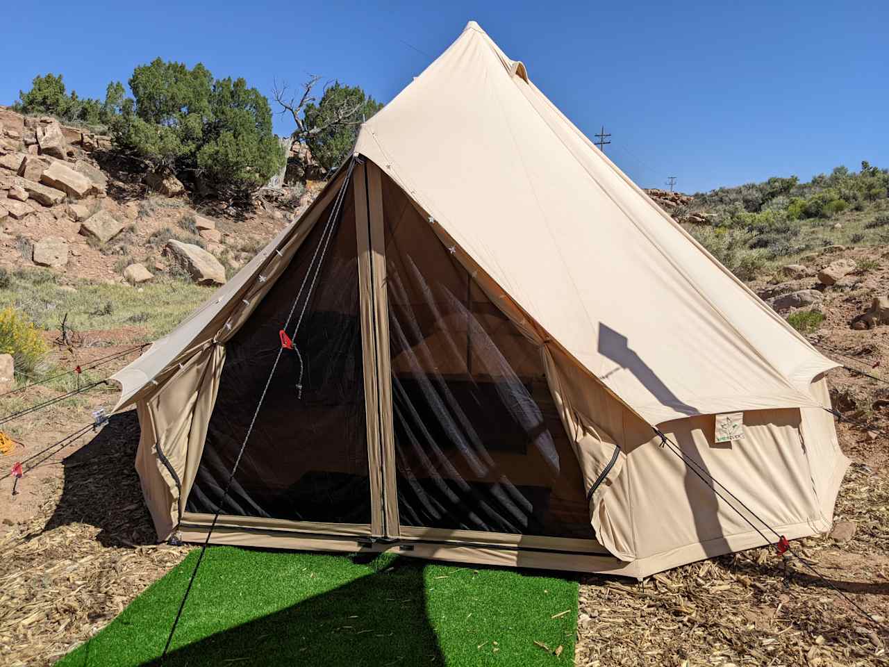 Bell Tent. Very comfy Queen Size bed (on a frame), an end table and a couple chairs inside