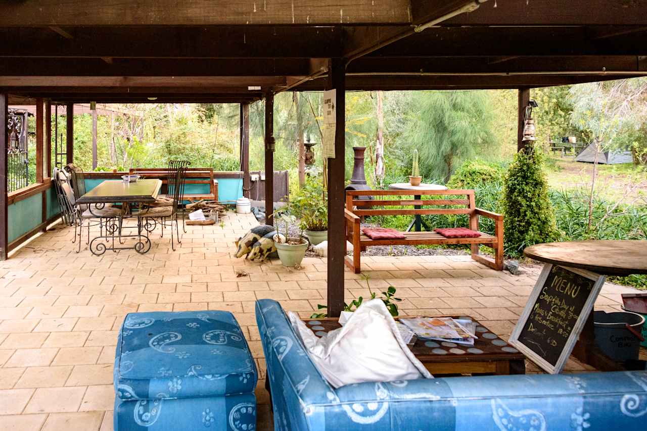 Undercover shared area with lots of seating, a BBQ and basic kitchen facilities