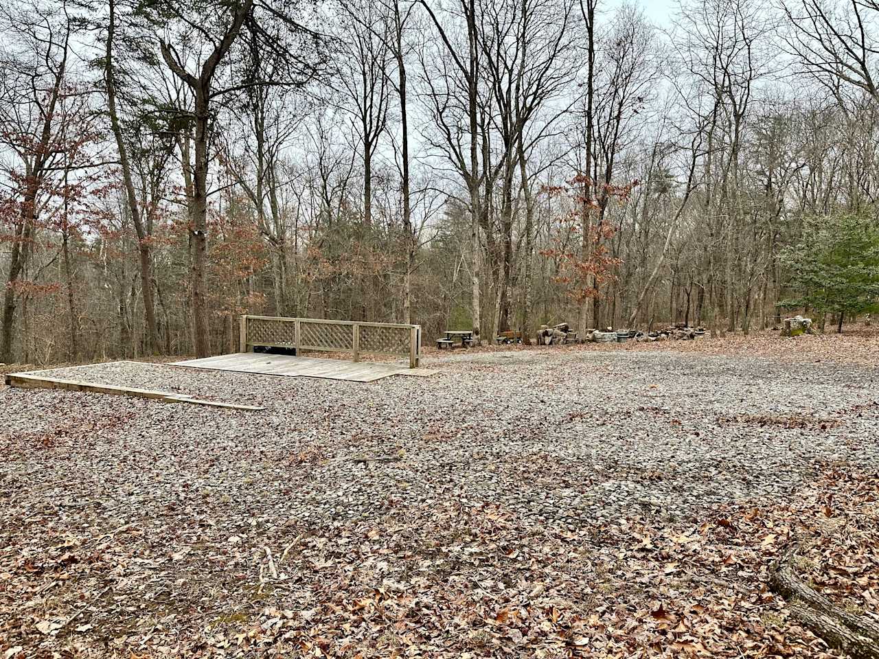 Gravel RV pad w/WiFi, full hookups (30 amp electric, septic, city water), trash bins, picnic table, fire pit, deck, and 8 acres to explore