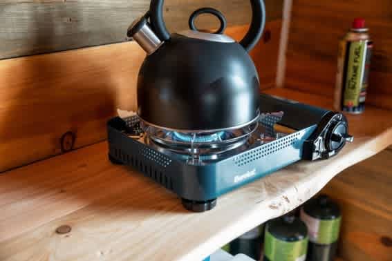 Tea kettle on propane stove for guests use.