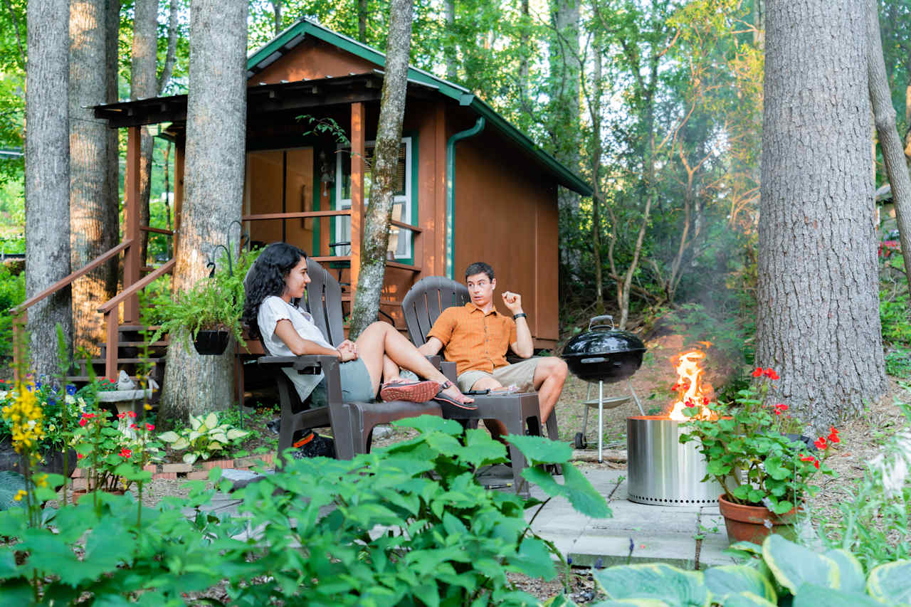 Sitting by the fire outside of The Nest cabin. 