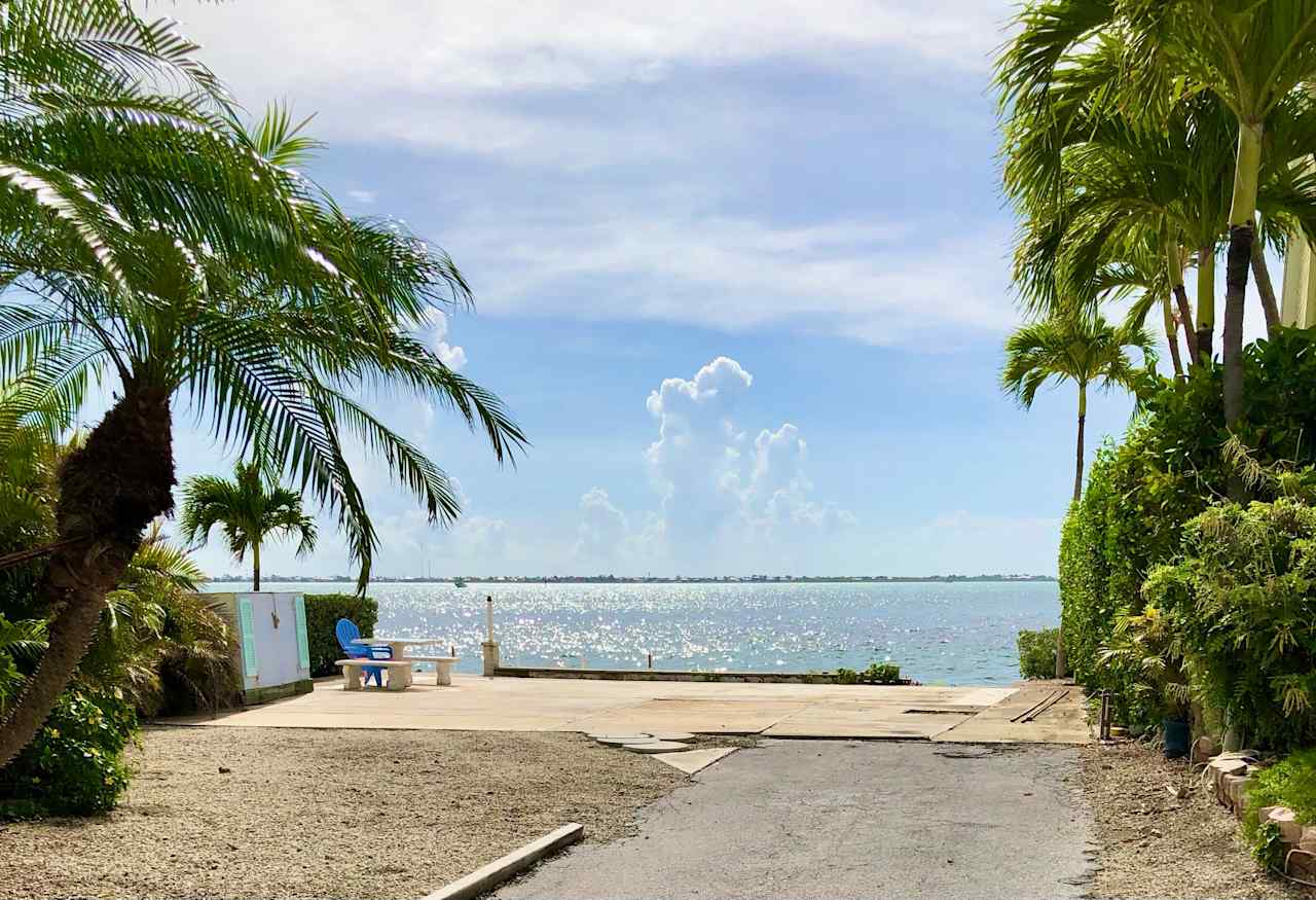 This is the RV lot from the street.  Lots of tropical plants and trees help keep you private.  The 57 foot seawall is straight ahead.