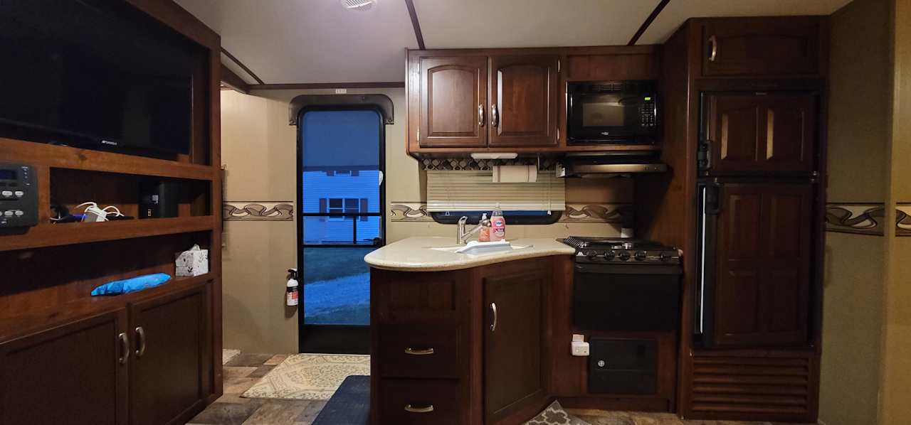 Living Area With Kitchen Keurig, Stove, Microwave, and Fridge