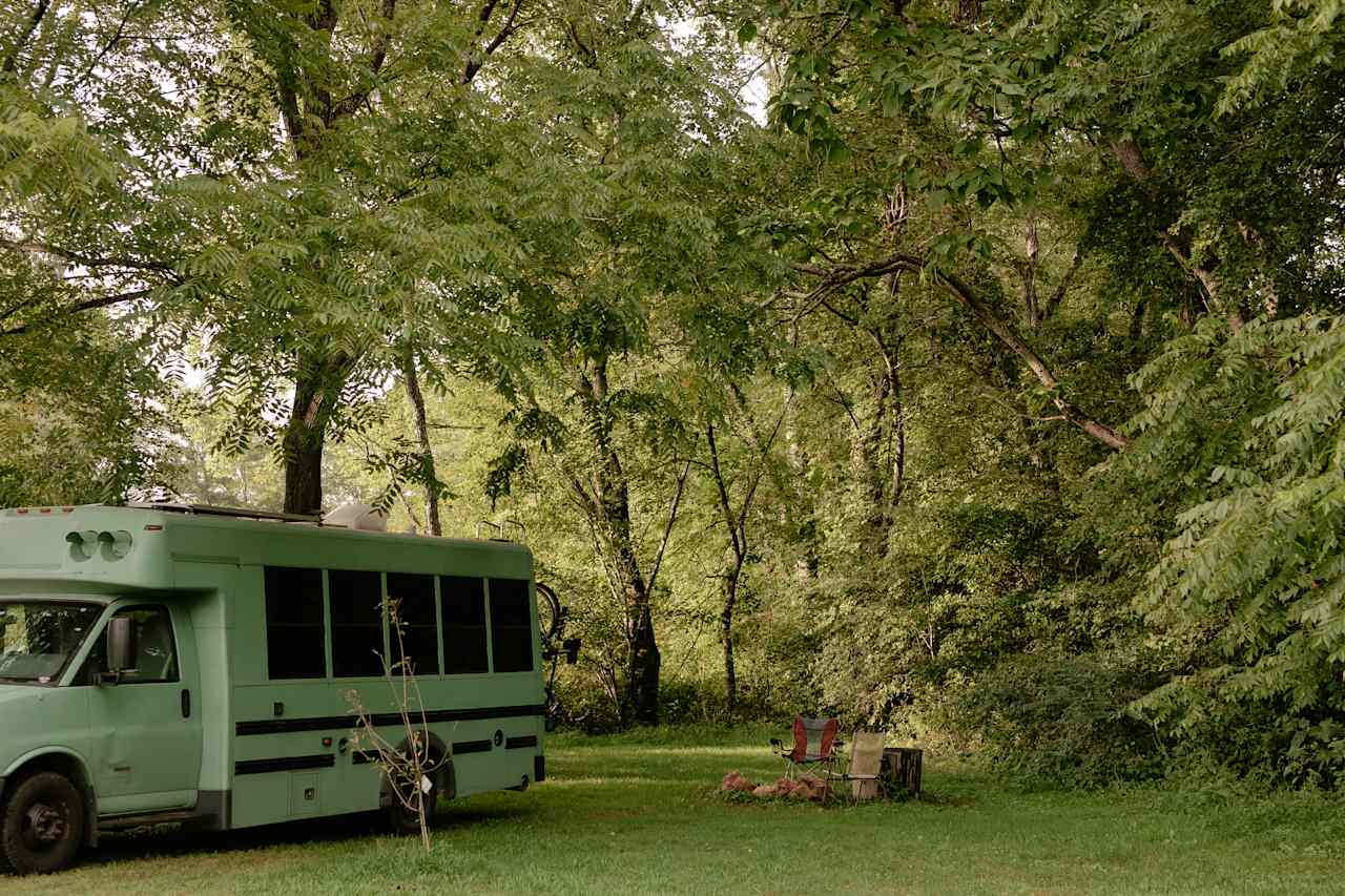 A beautiful canopy of trees above a level campsite. There's even a short trail to a portapotty between that trees. It's cleaned weekly! 