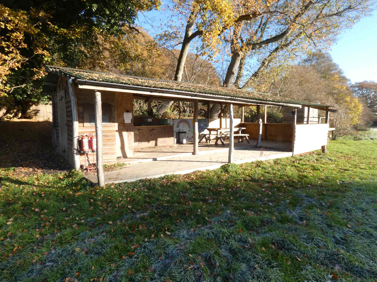 A large camp kitchen has two sinks with hot running water and selection of seating.