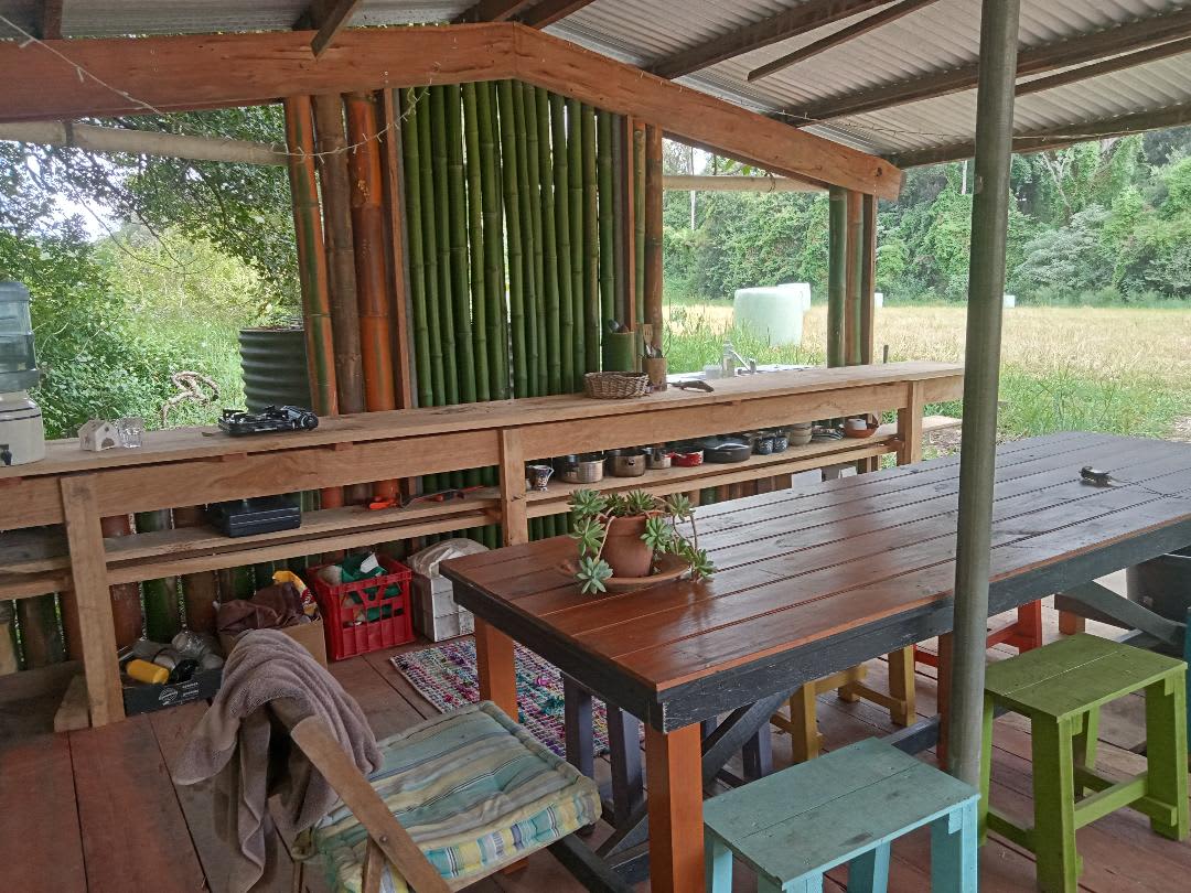 undercover communal kitchen / dining area with outside fire and shelter from the weather 