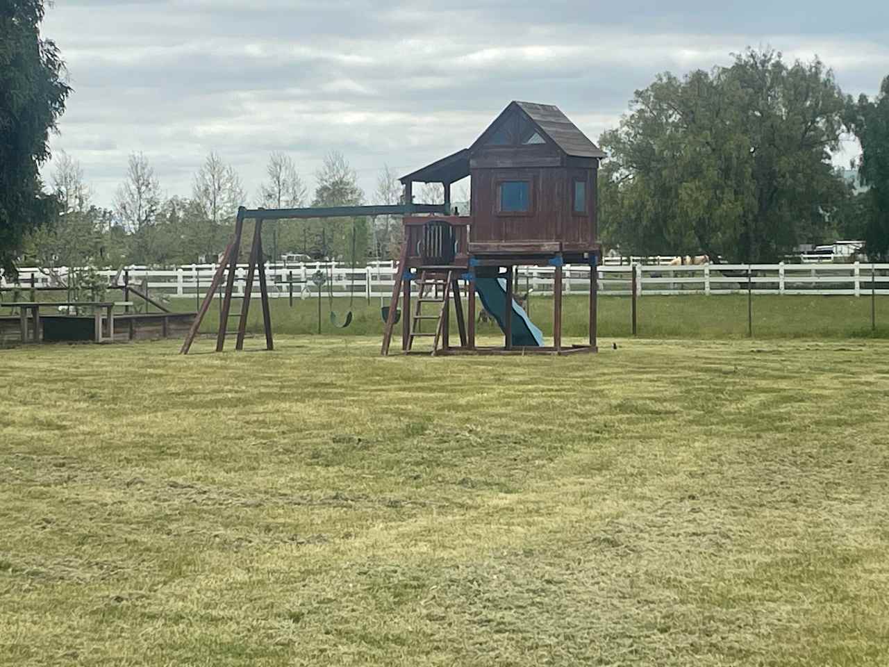 Kids play structure with swings, bar, slide and clubhouse! 