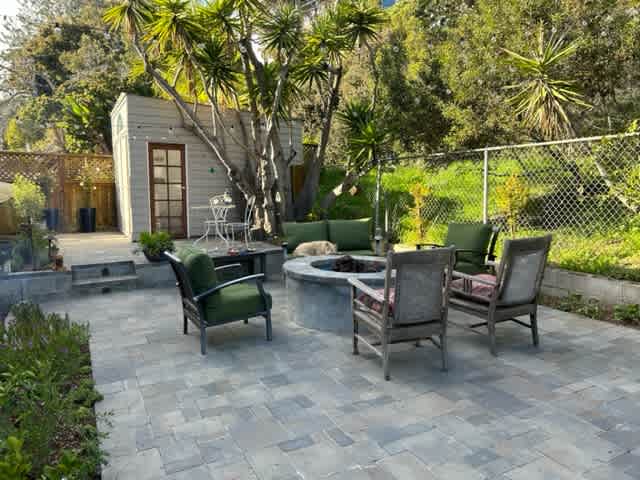 this is your cottage with an outside seating area with a gas firefeature