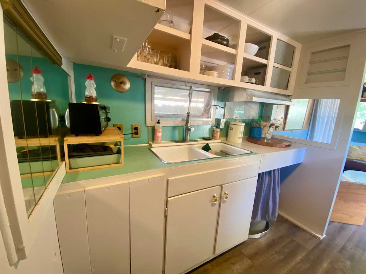 A small but functional kitchen.
Toaster, a fridge, double sink, and full oven. 