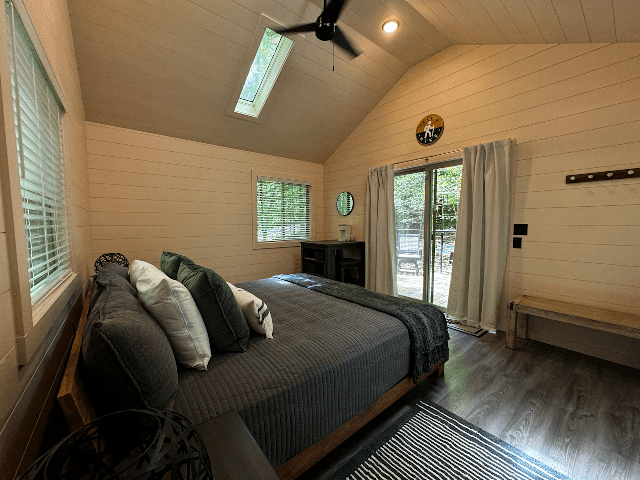 Dining Table/Desk complete with two stools for your convenience, Plush King-Sized Bed and Cozy Bench.