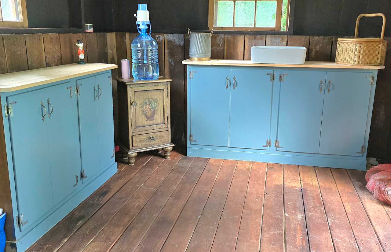 Cabinets for storage.  A water bubble for fresh water to drink, as well as to use to wash dishes in the sink that drains to the outside tank.