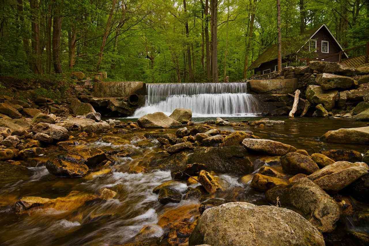 Our waterfall is located just behind the office, just sets from your campsite. 