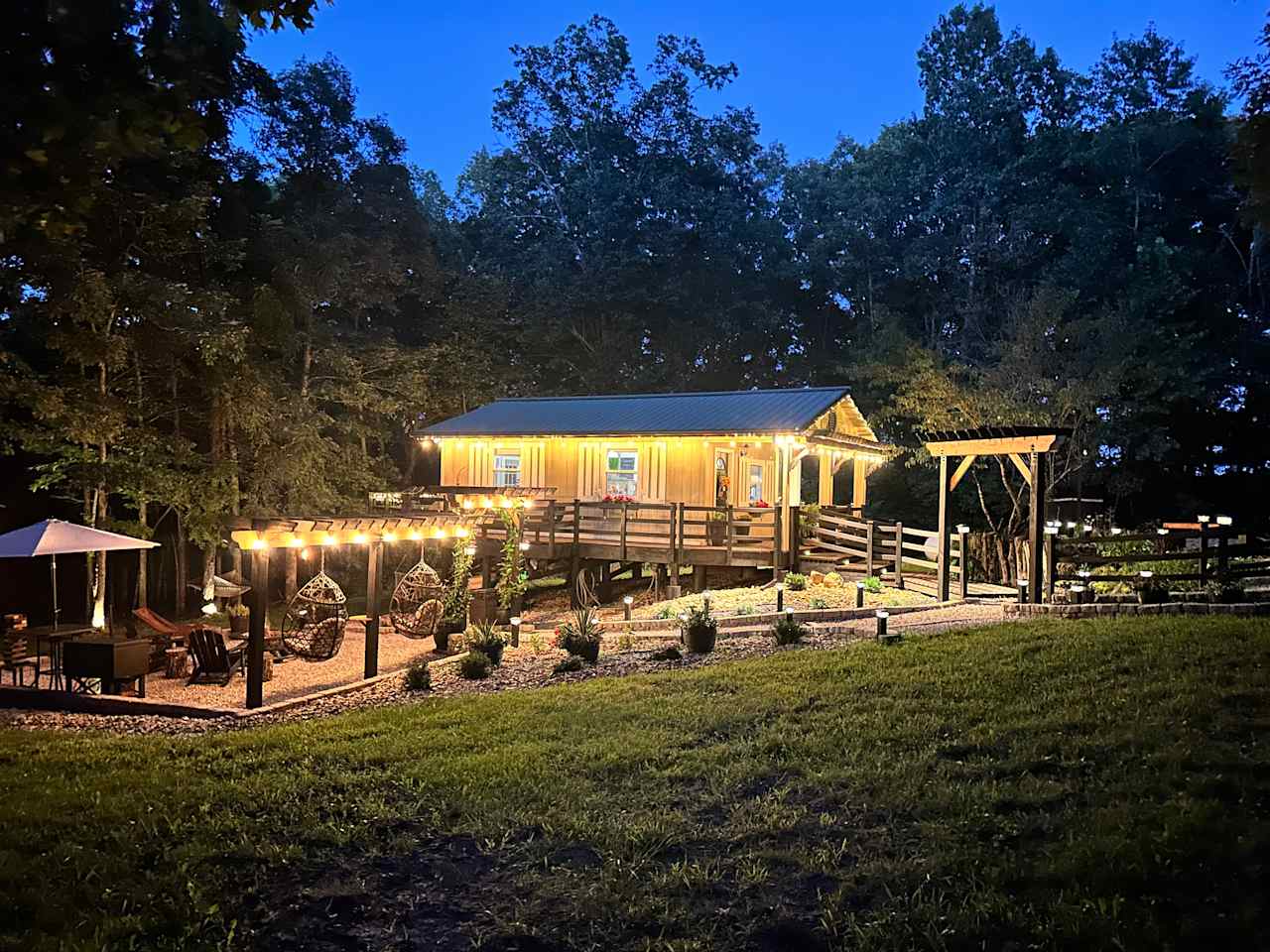The Arbor Cabin in the woods.  Enjoy a lighted beautiful outdoor space complete with BBQ. Firepit, Hanging Chairs and more!