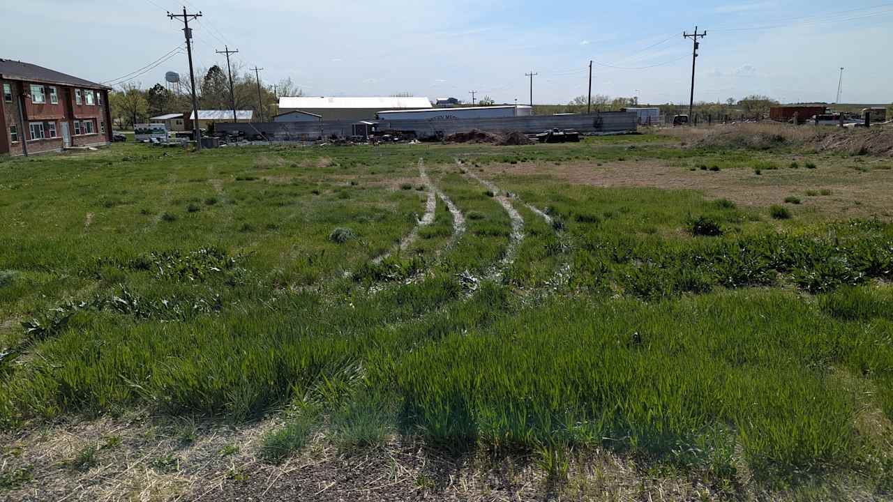 We are a work in progress. This is the view from the dirt street to the east to enter the space. There are a few ruts to navigate.  