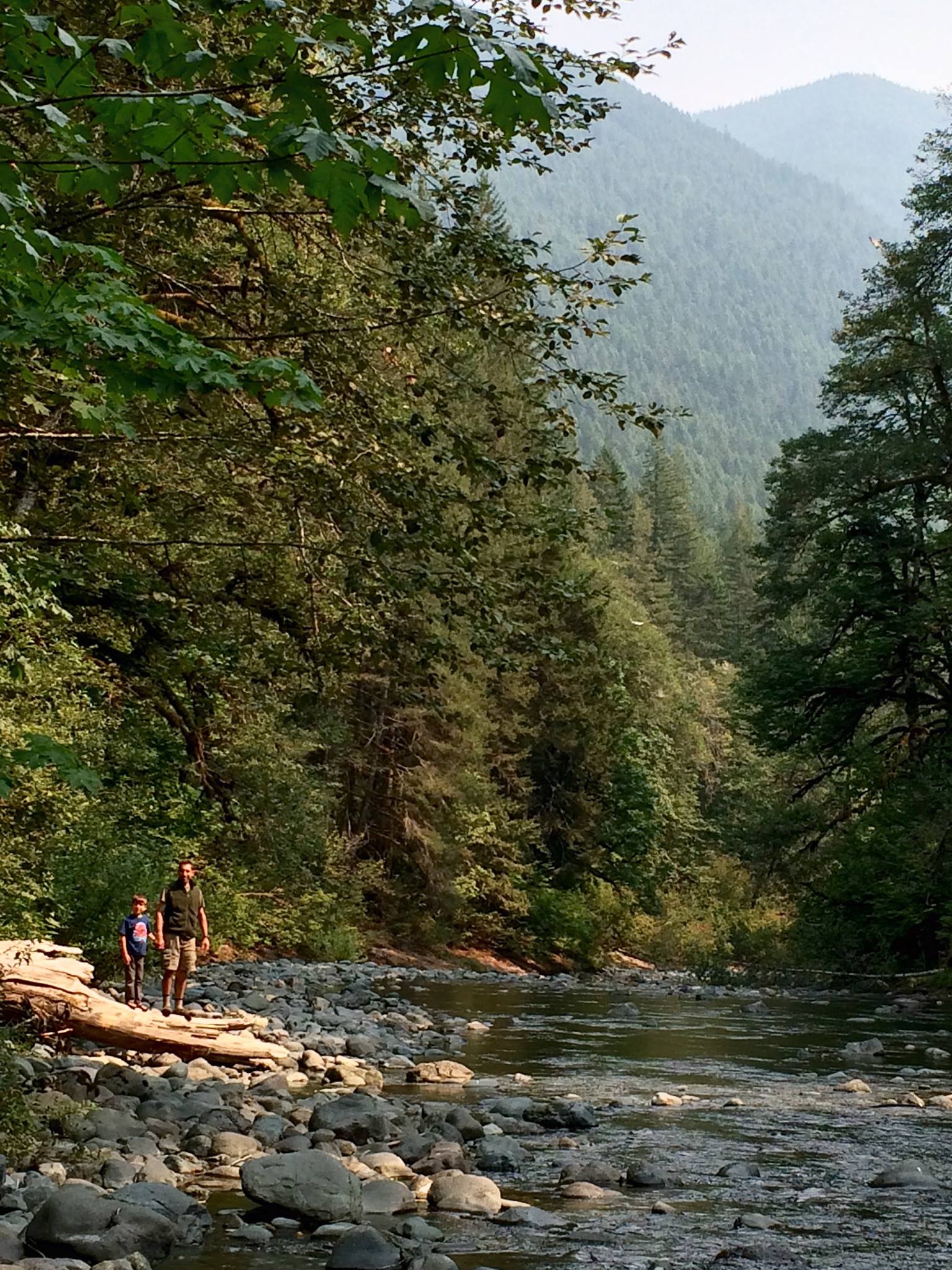 My husband and son, standing beside the river.