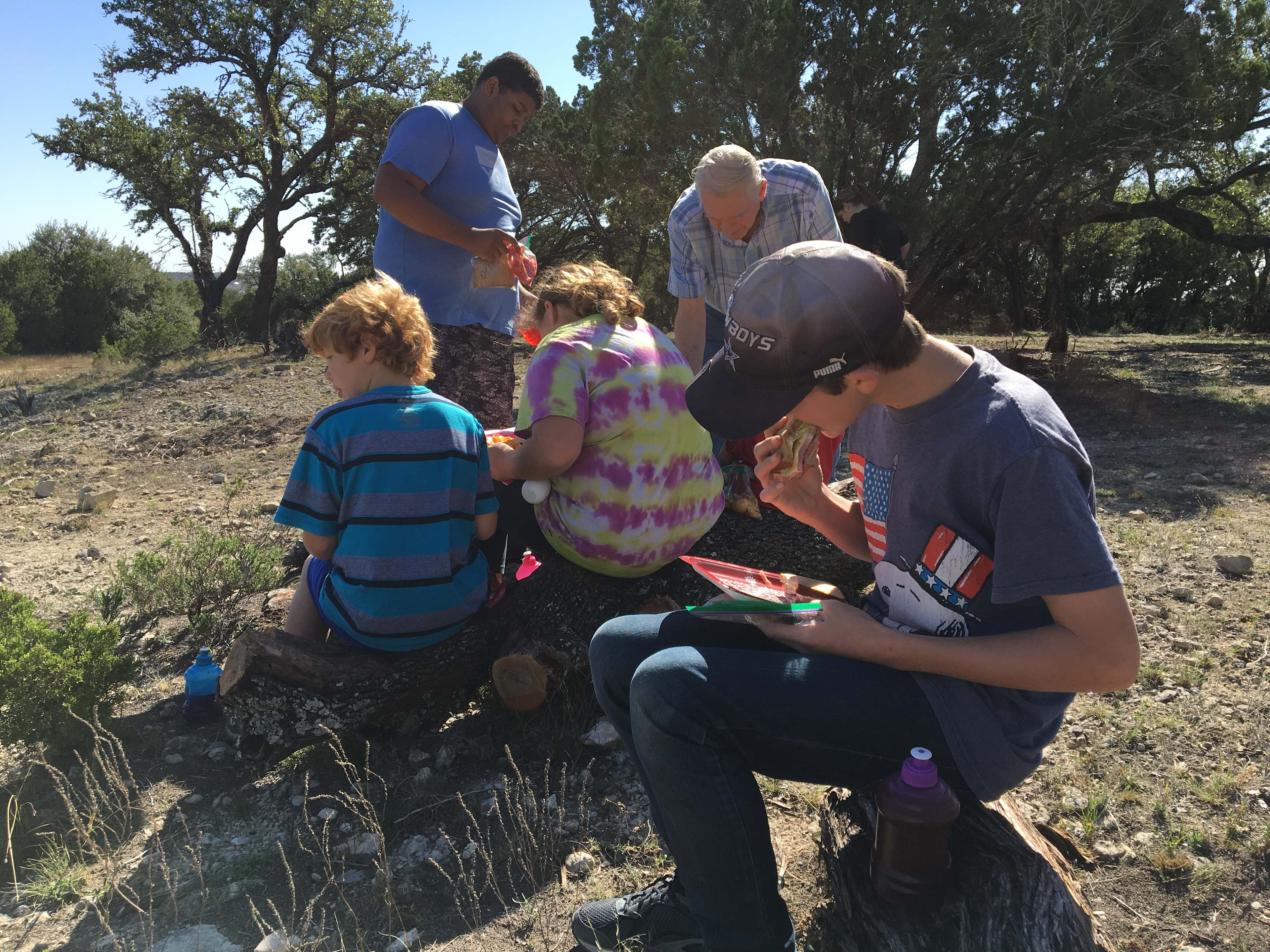 Grandkids eating sandwiches  on West Side/Cliff Side Of Lake! 