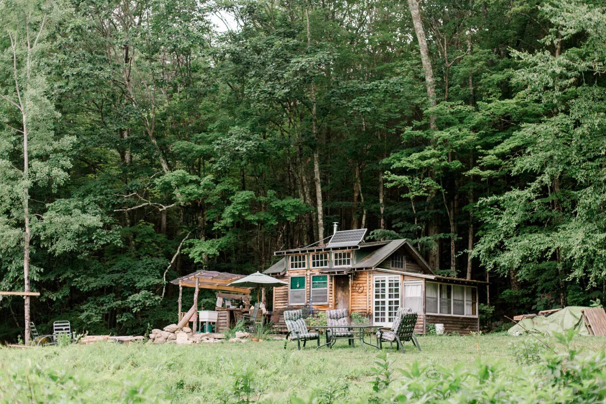 View of the cabin while walking up the wooded path from the parking area