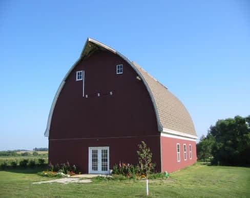 Our barn dormitory with 7 bedrooms, a lounge, men's and women's restrooms with showers, and kitchenette on the lower level.  The upper level has a full kitchen, a large dining hall/dance hall, and a stage.