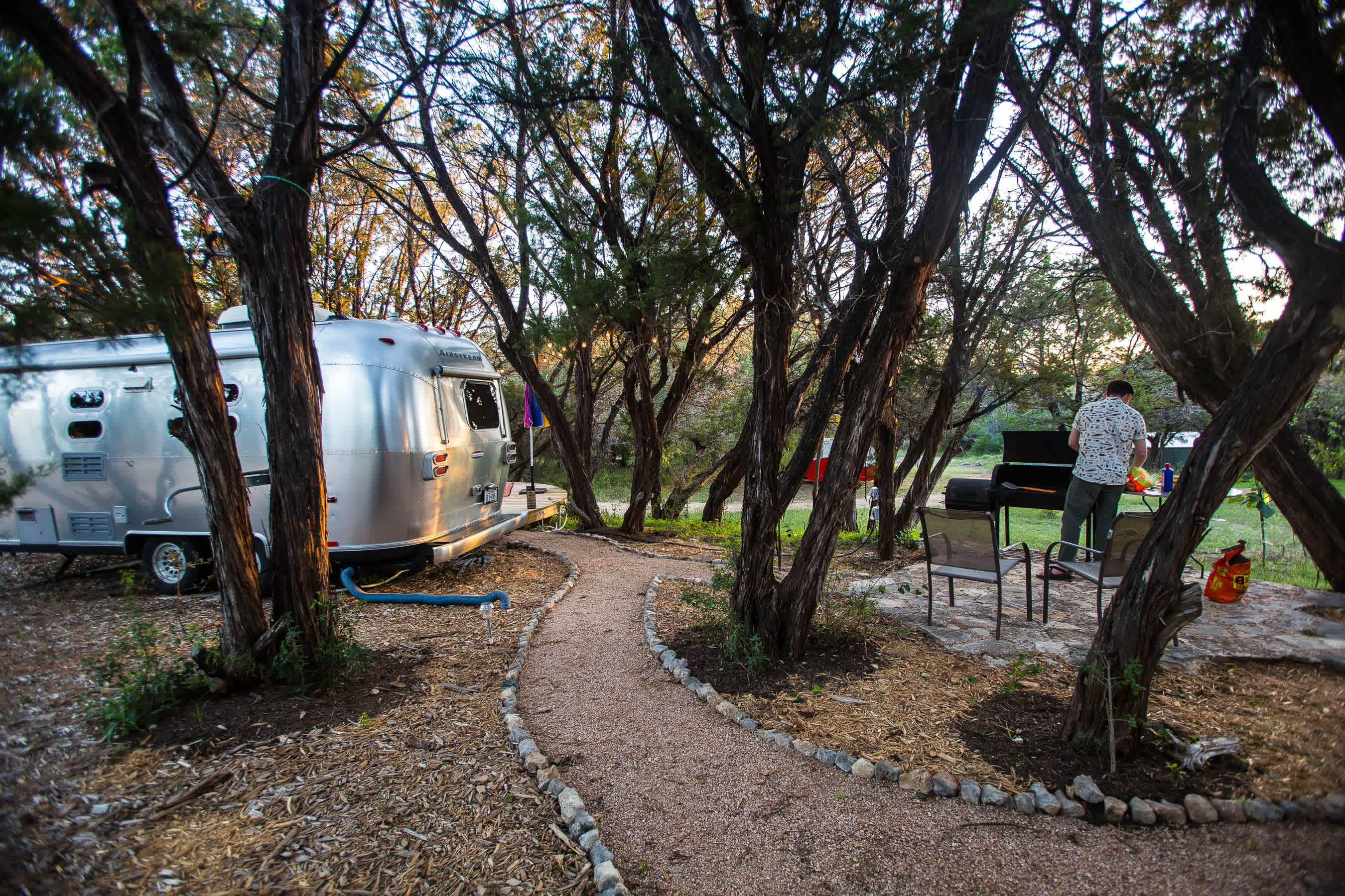 Prepping dinner at the grill that's set up right next to the airstream.