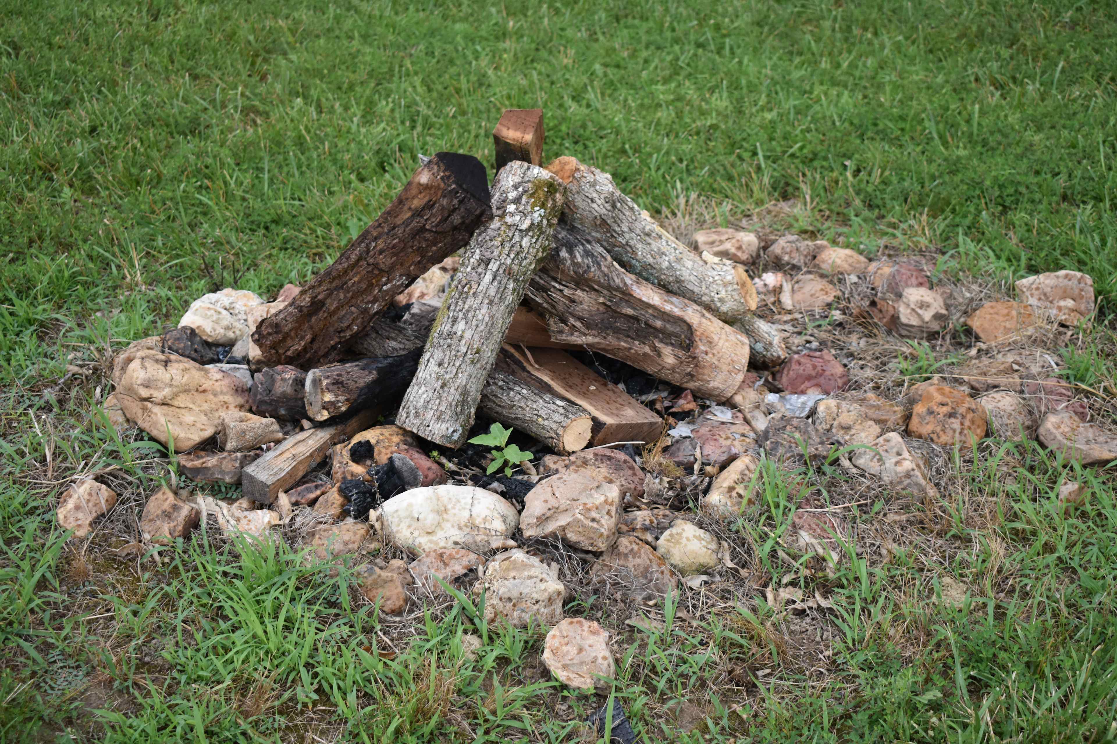 Firepit with a bundle of wood.