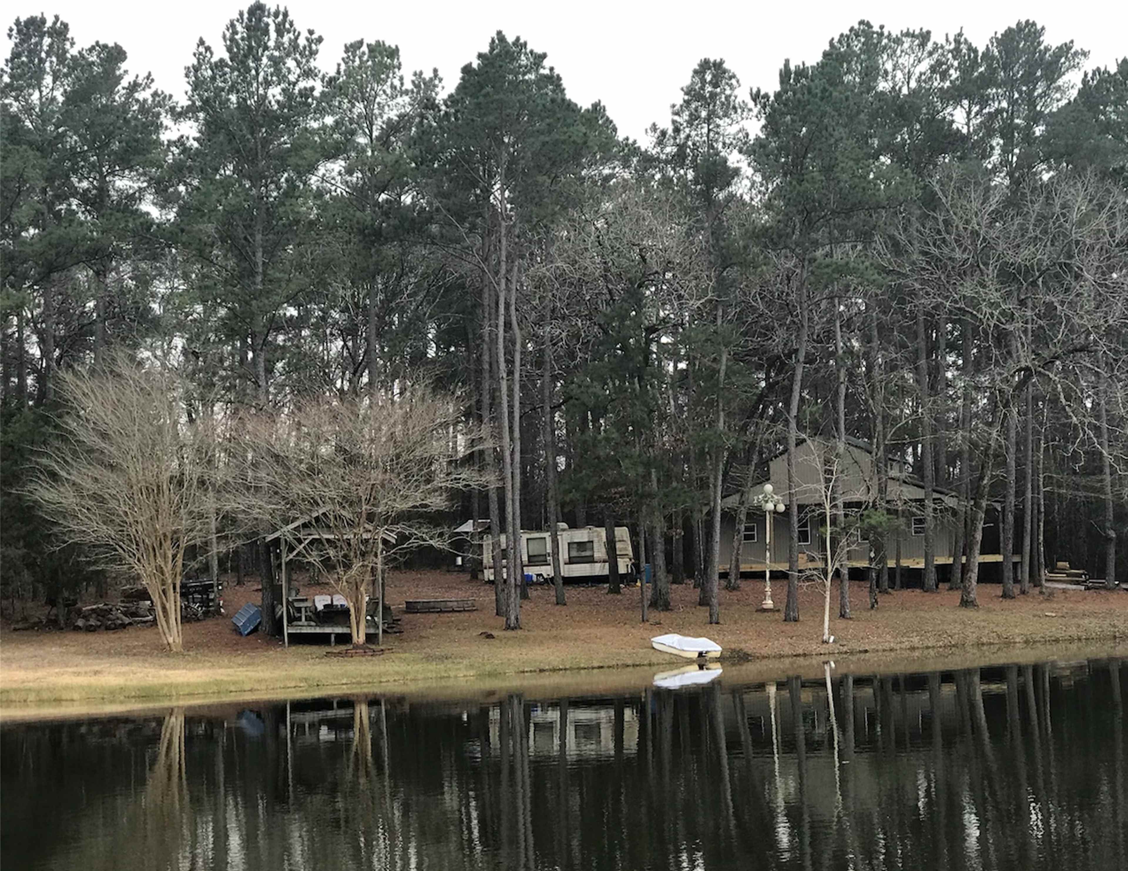 View of land from pond. The house in the background is still under construction. 