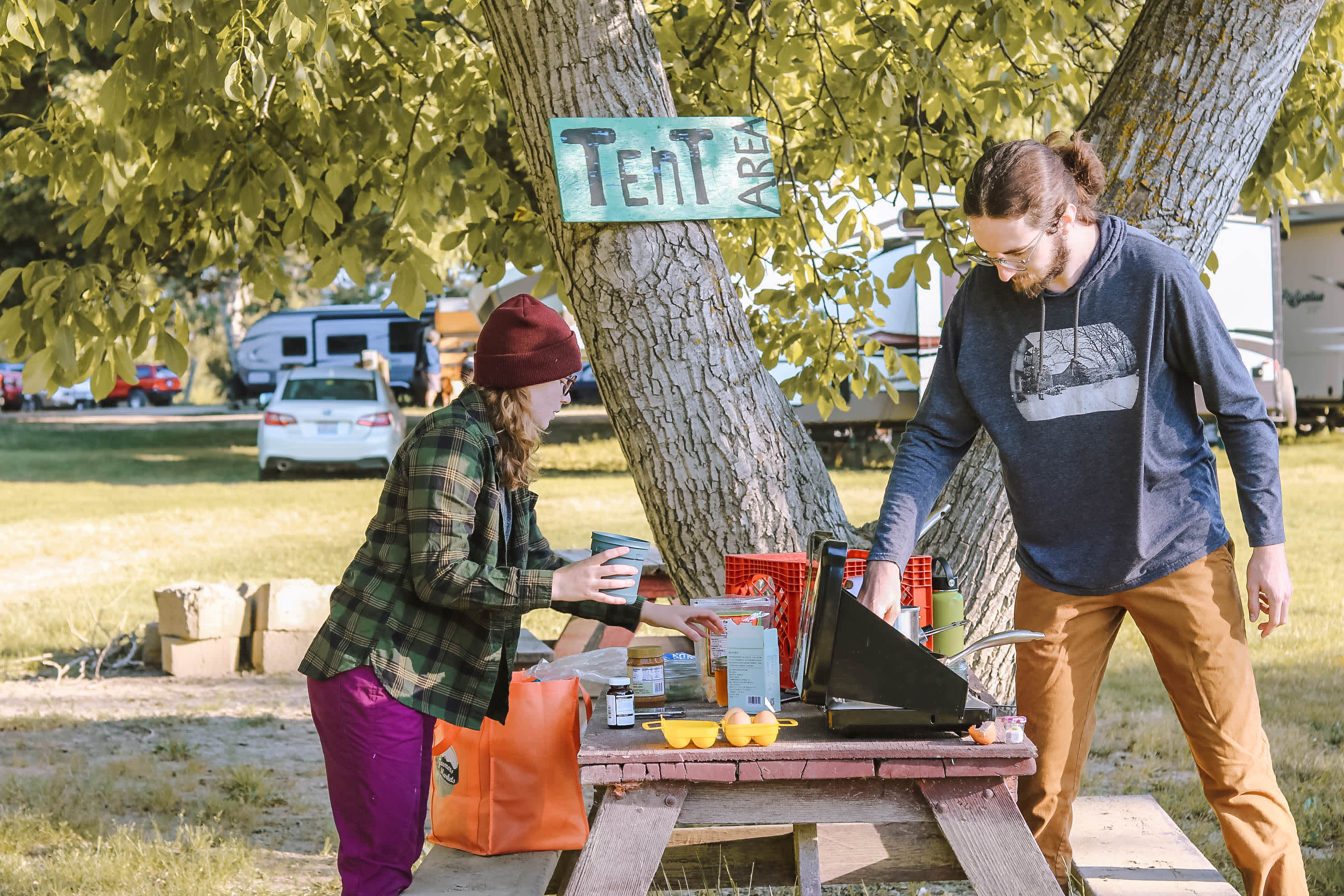 Making breakfast on one of the picnic tables in the tent area