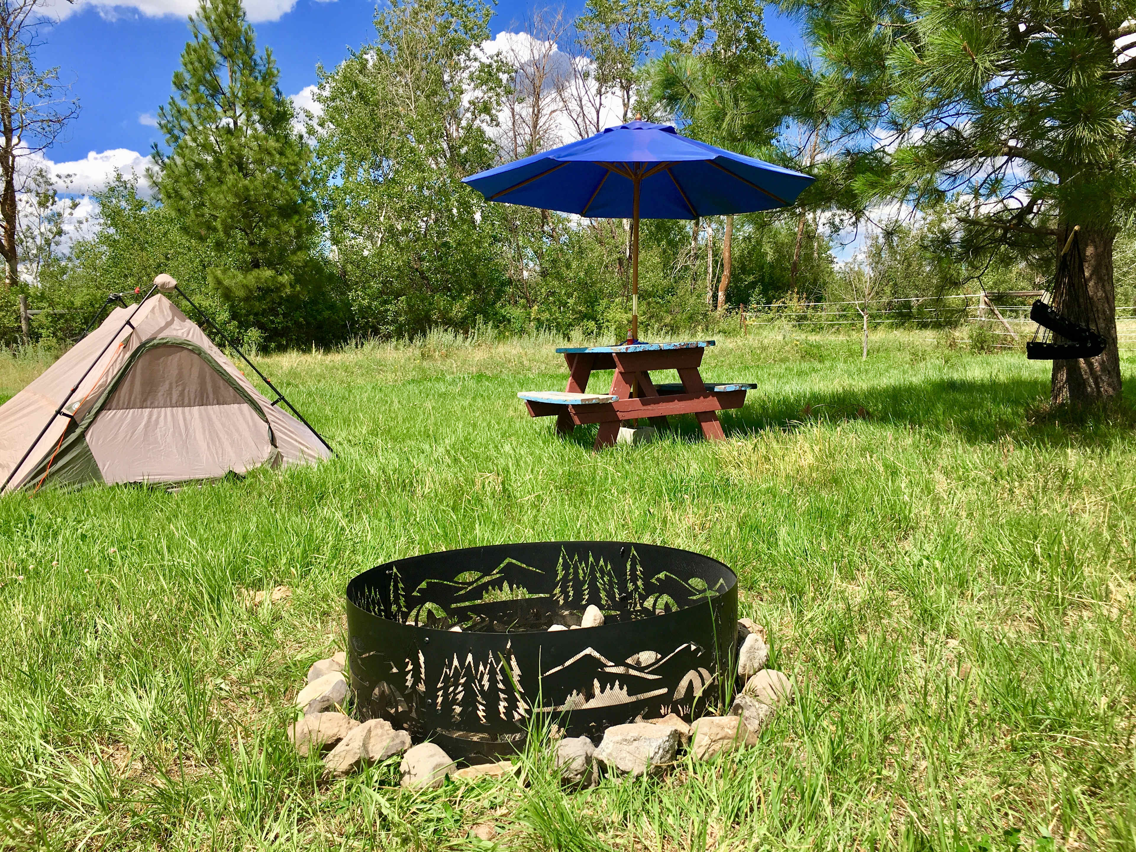 Campsite 4, hammock chair, tents can be rented! $20 each tent. Cool fire ring here.. 