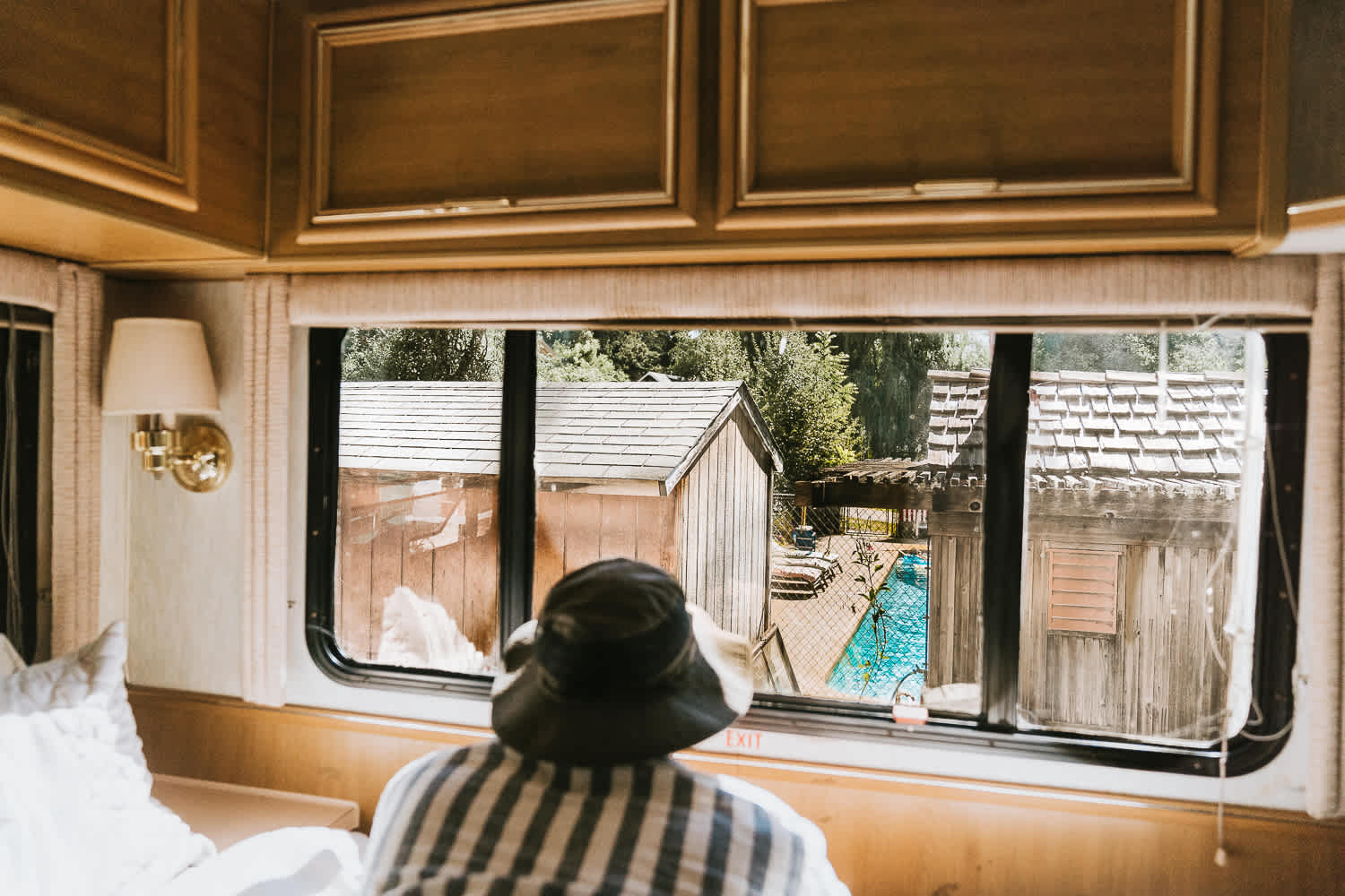 In the back of the RV is the double sized bed with a view of the pool.