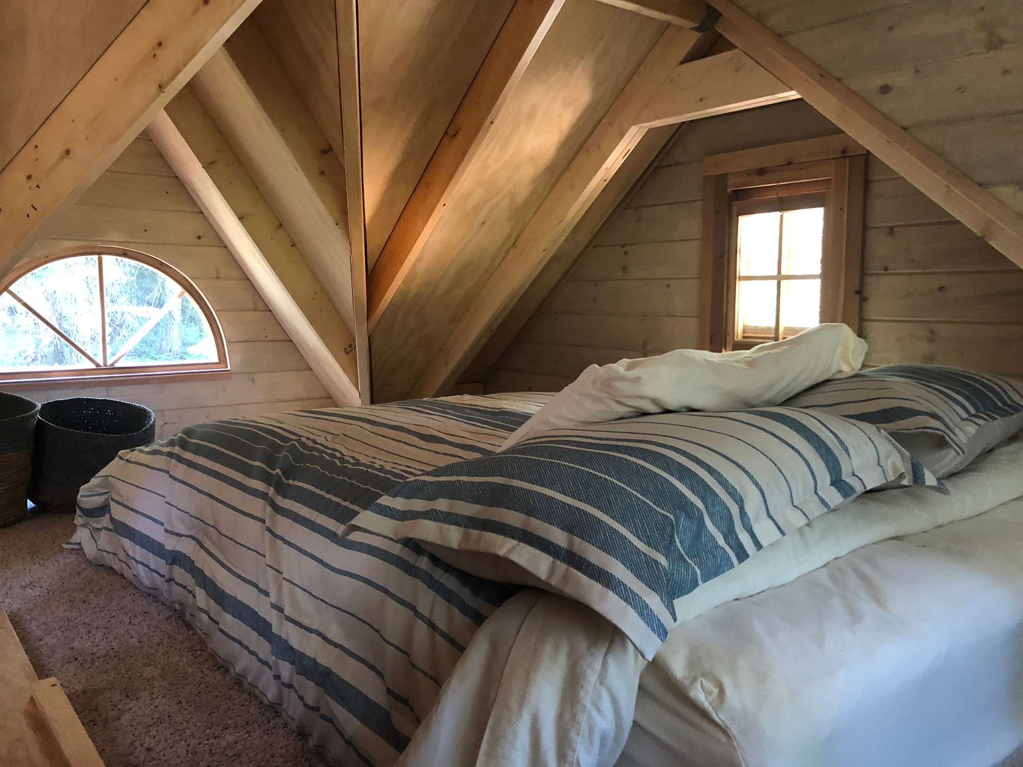 Comfy upstairs sleeping loft with four windows.