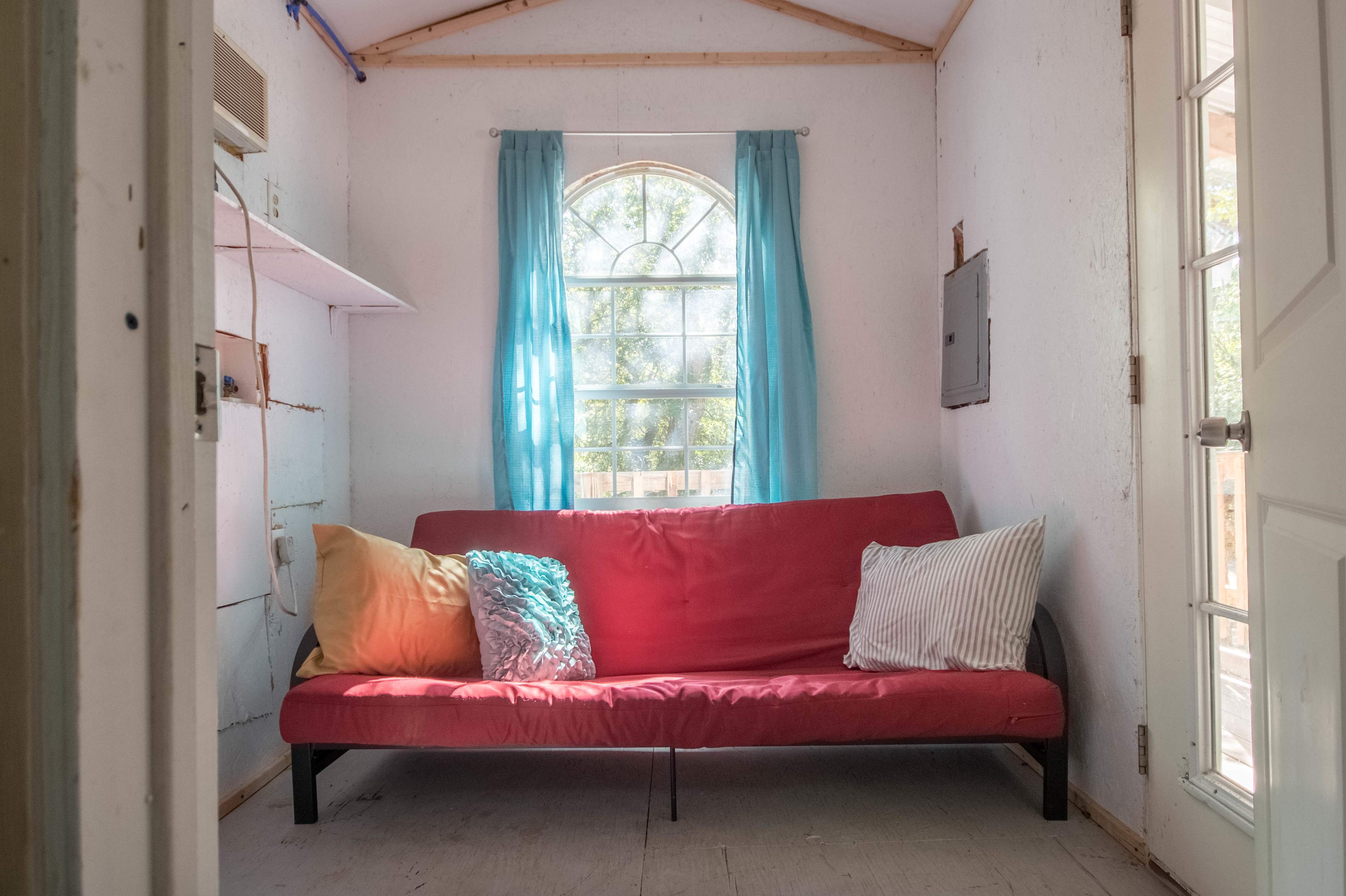 The top story had a futon and beautiful natural lighting