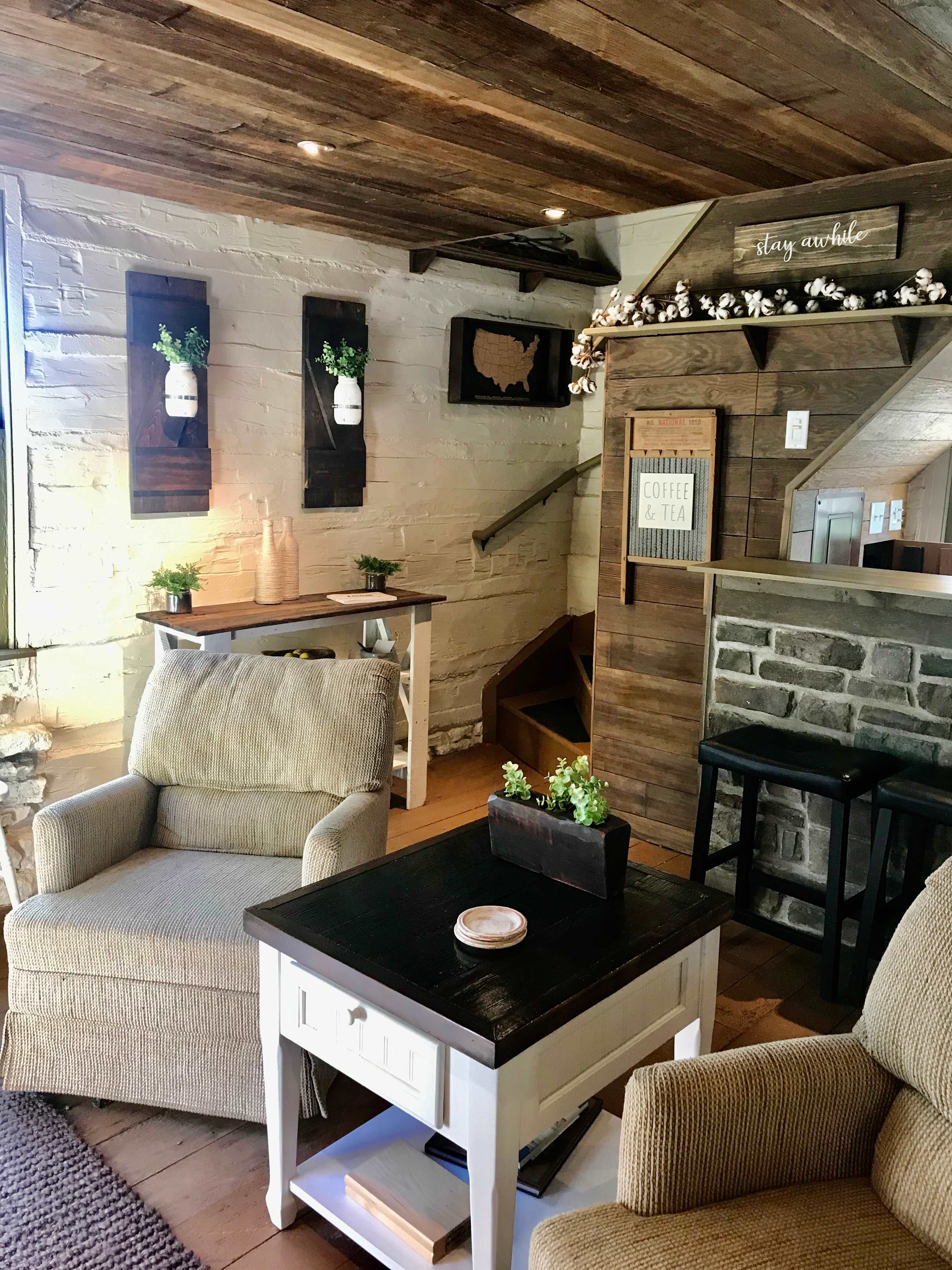 View of sitting area and stairway entrance.