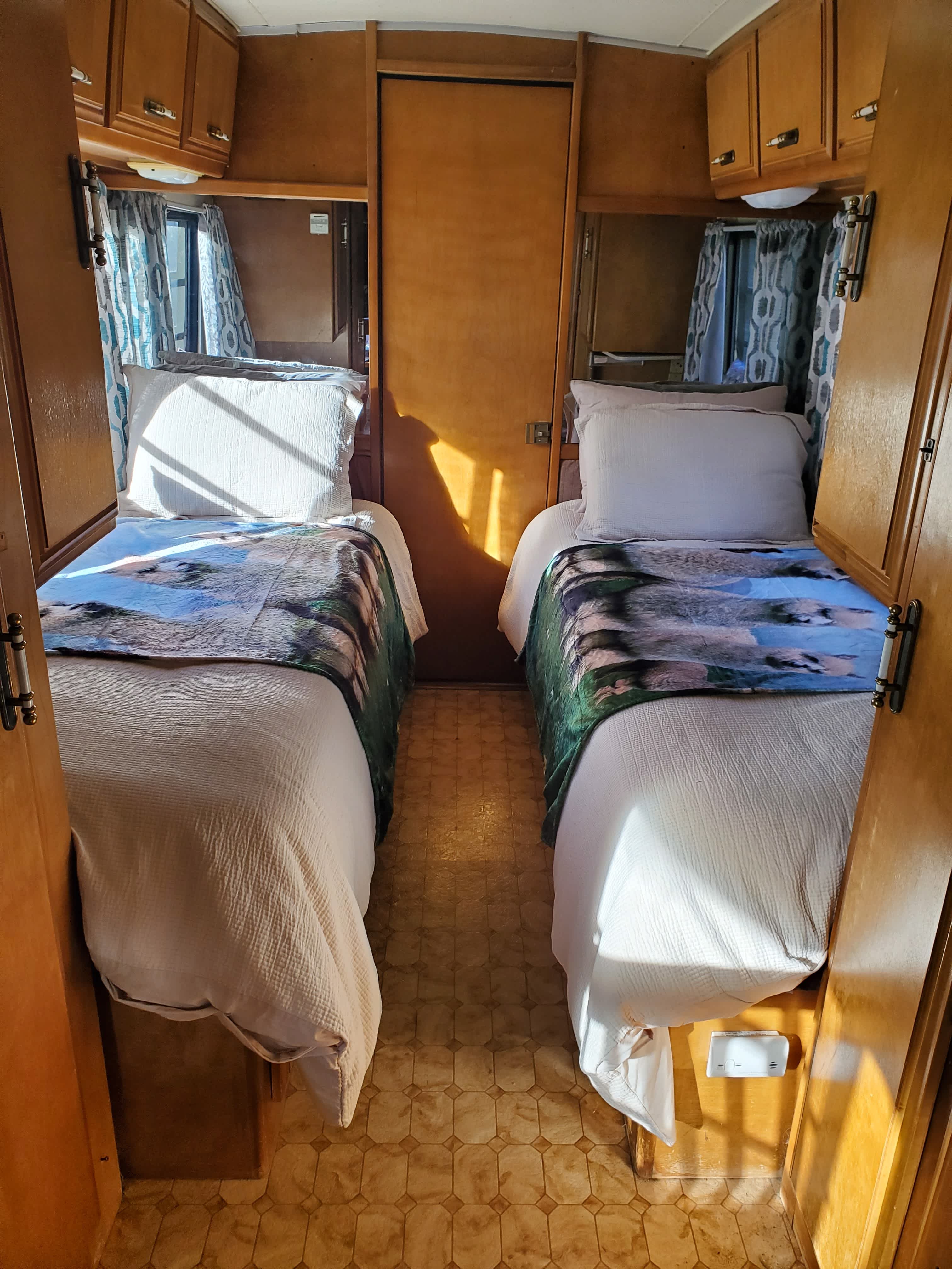 Avion also has twin beds and door in the back leads to a full bathroom. 