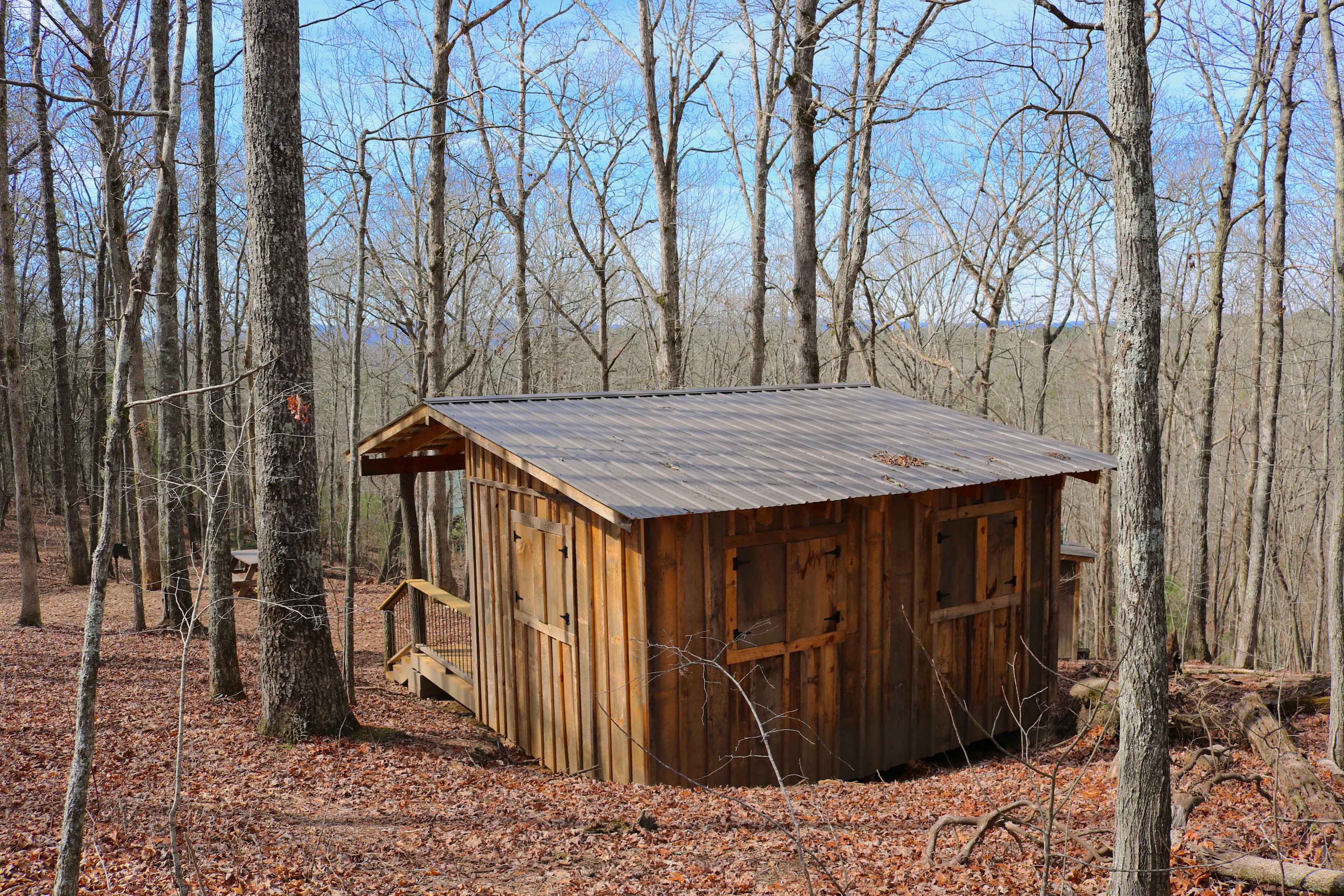 the Mountaintop shelter is nestled in the hillside and has four big windows with storm shutters
