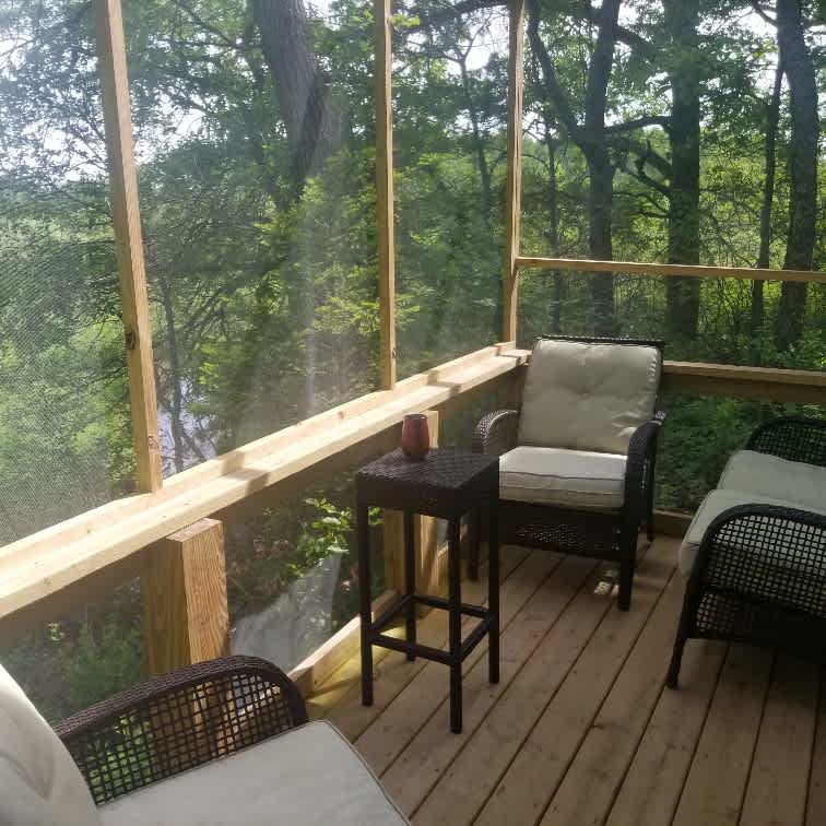 Screened in deck overlooking stream
