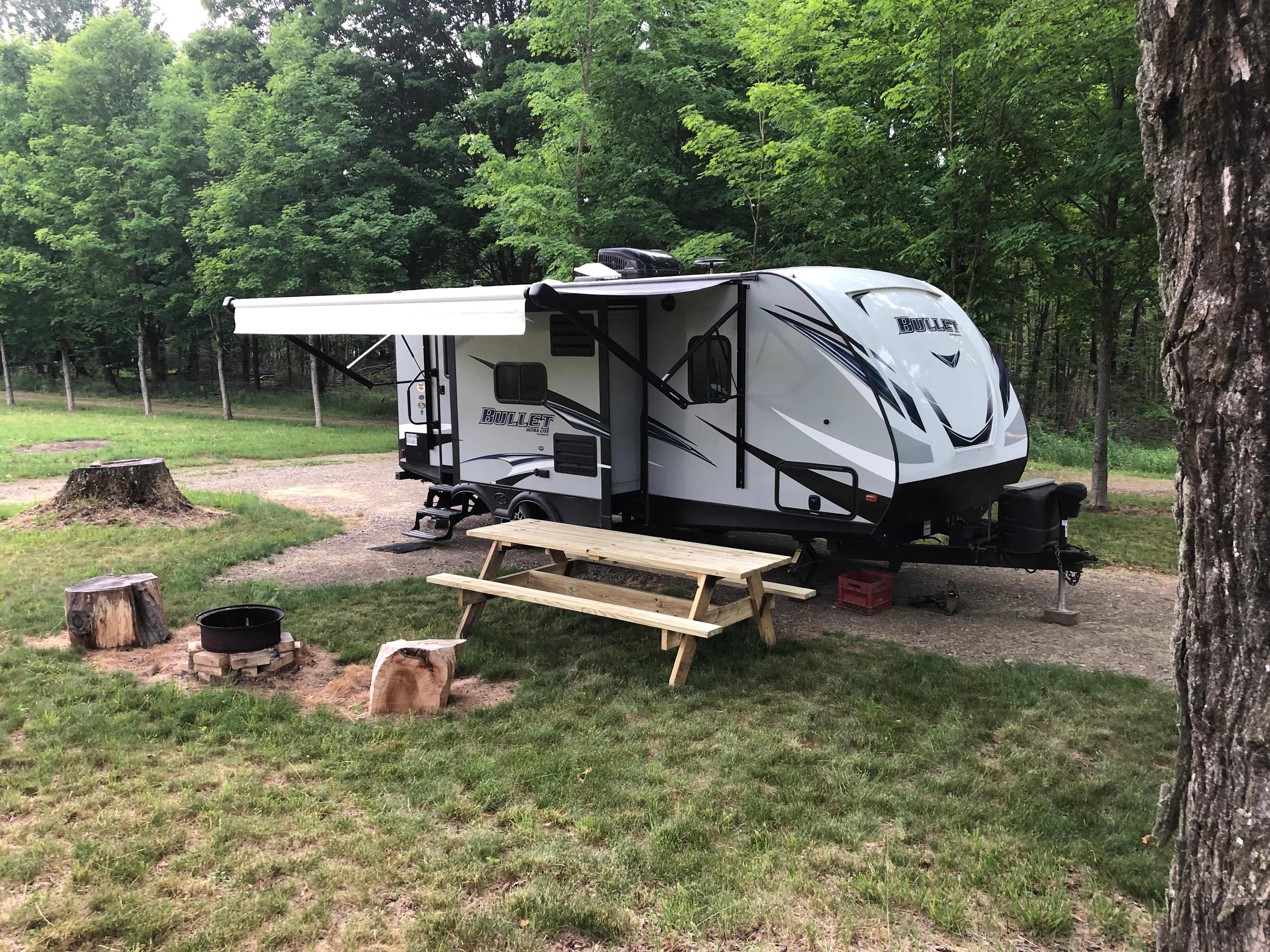 This is camp site #1. It is gravel and level surrounded by mowed grass. The camper is not for rent; it is set up for demonstration purpose