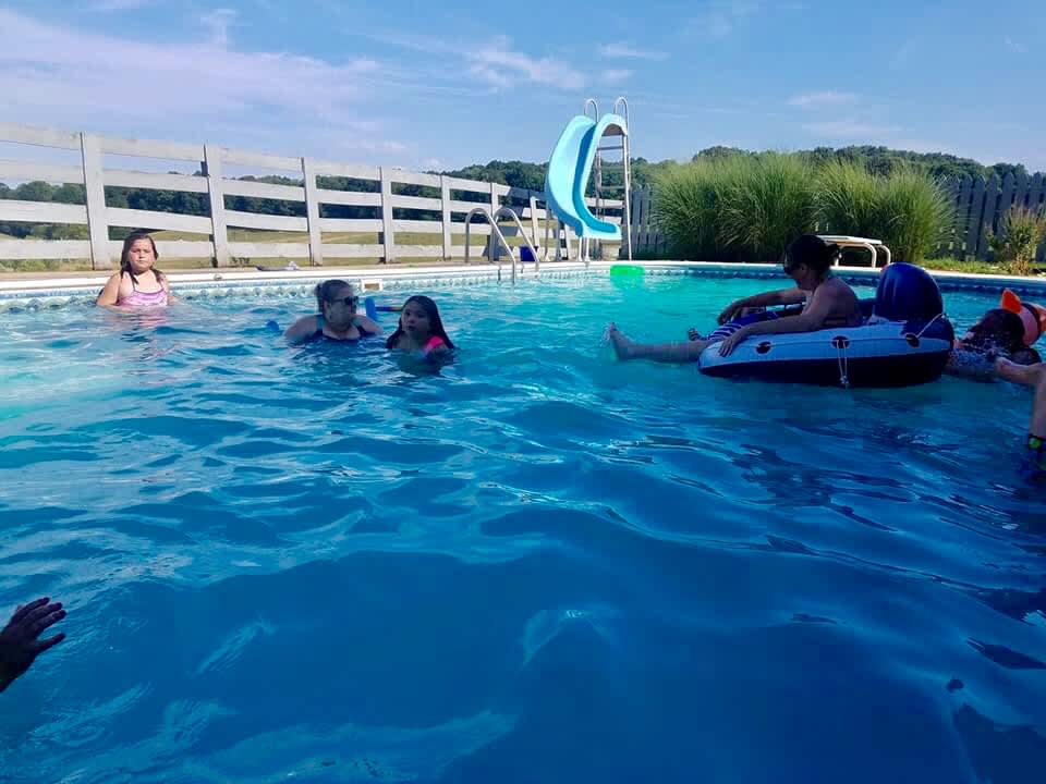 This pool is located a short driving distance away on property.