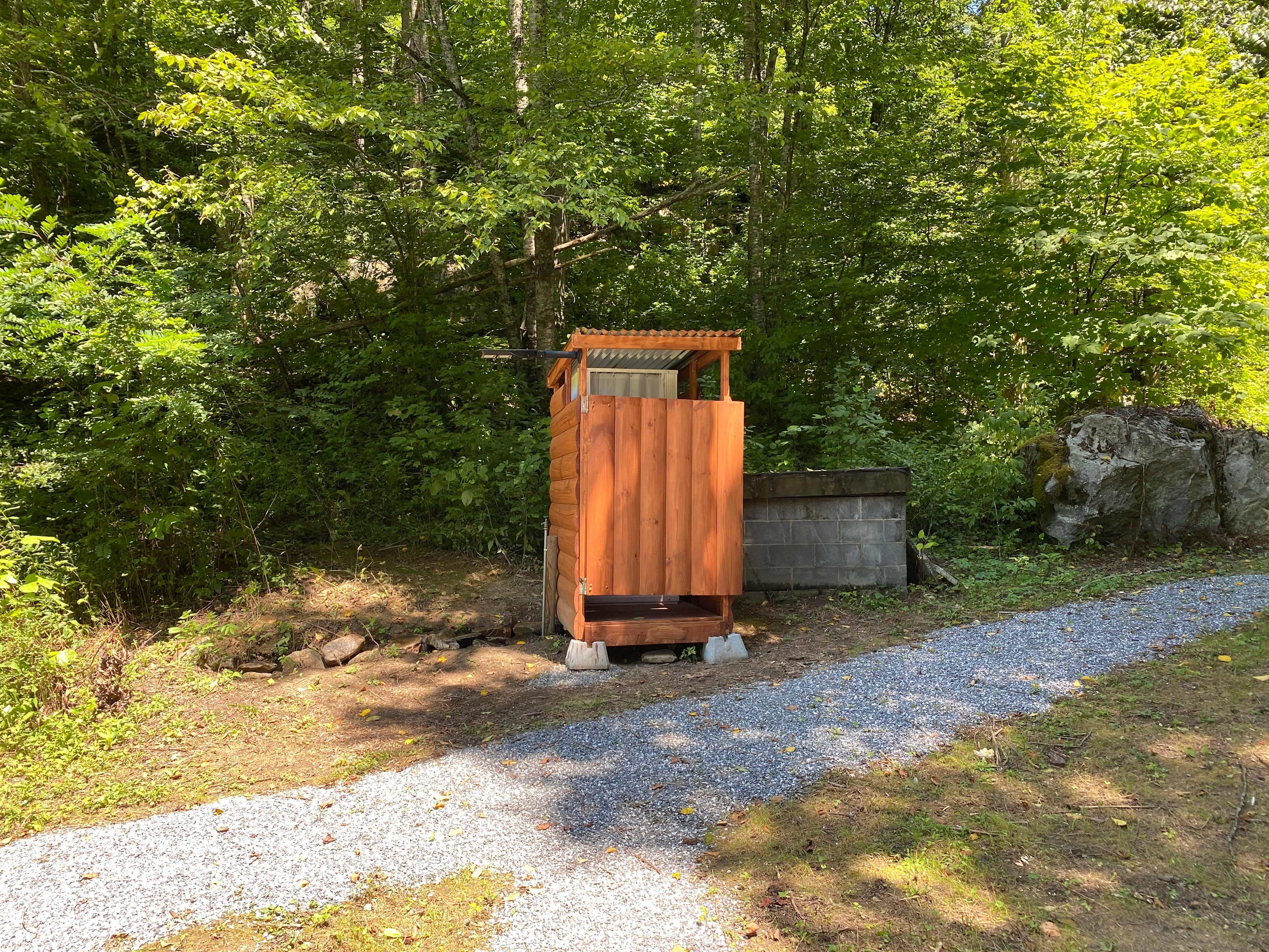 Simple shower with Thedford 365 toilet and outside spigot 