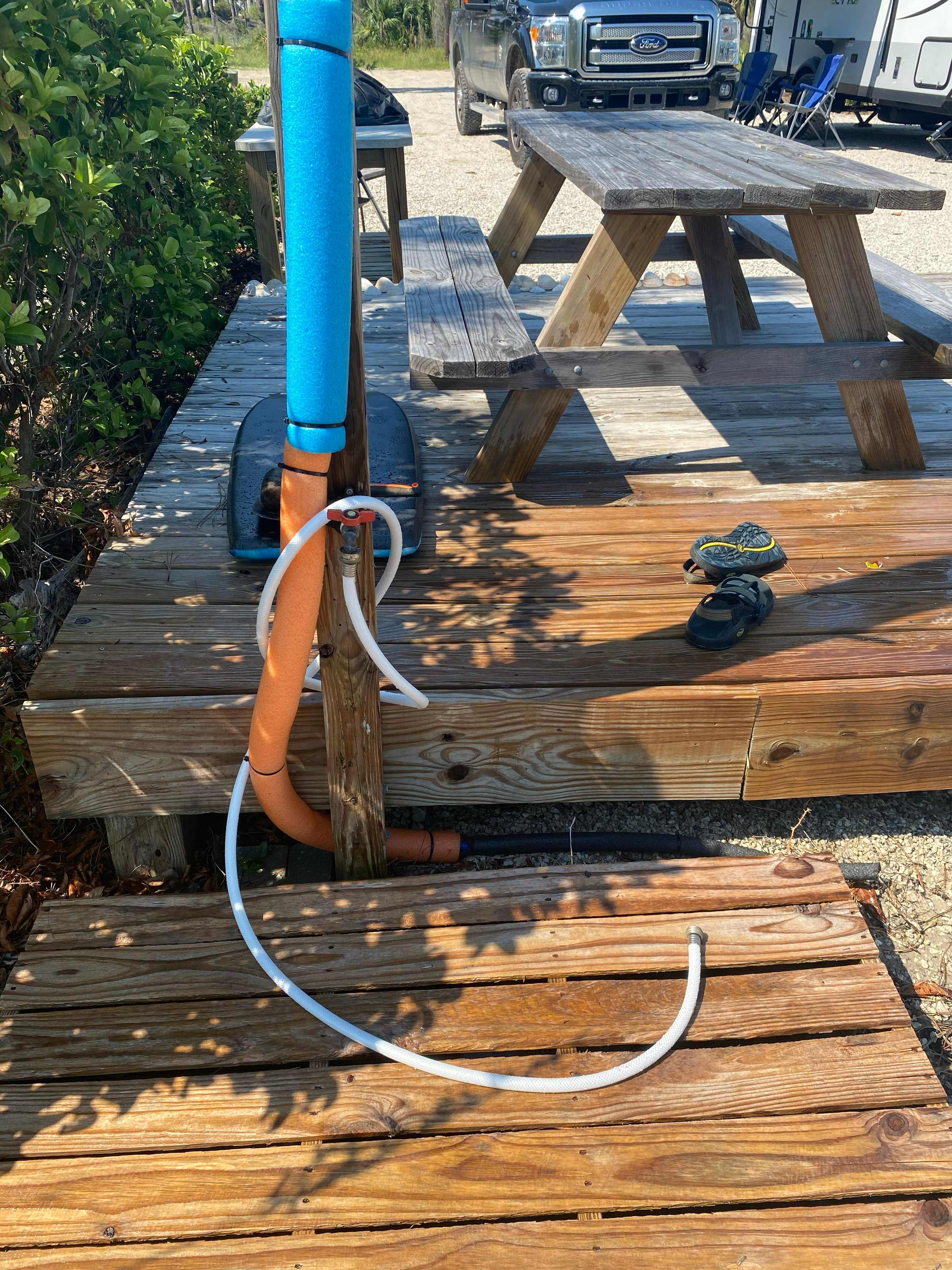 Outdoor shower plus hose for washing off sand and beach gear.