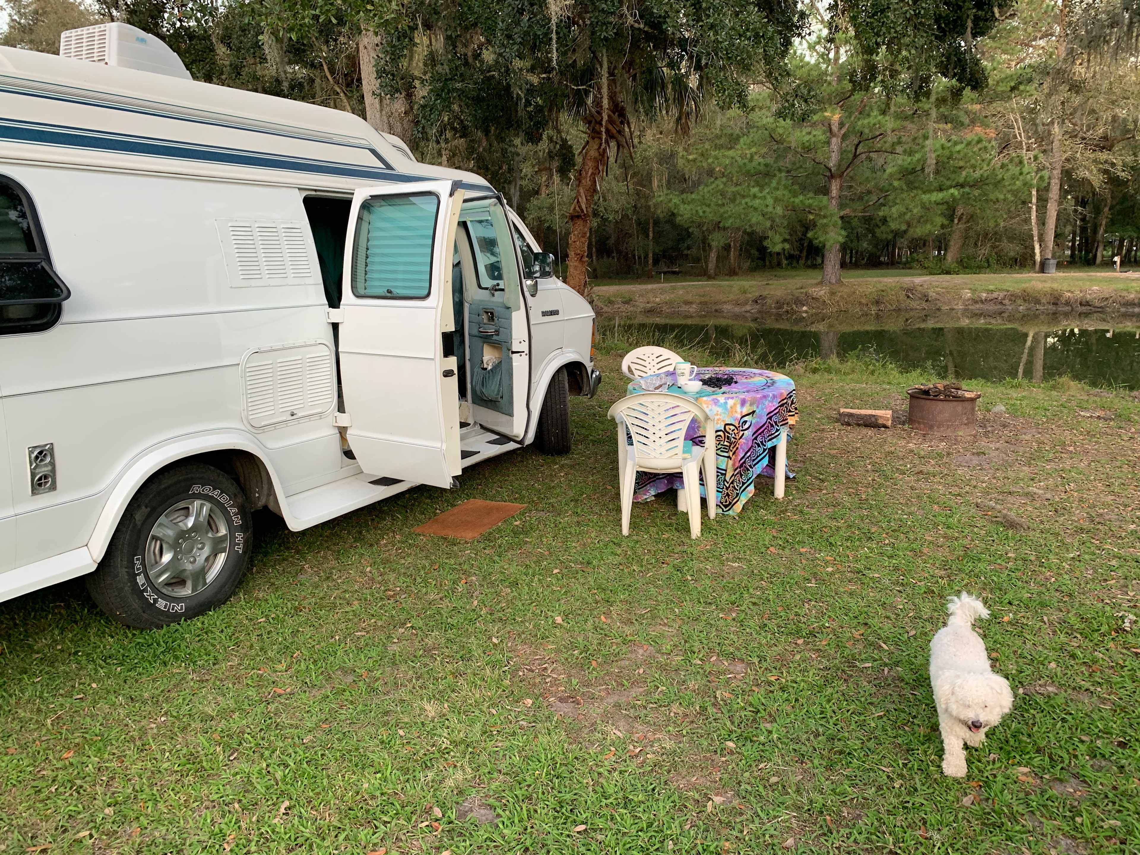 Parked in front of the pond, under the oak trees. 