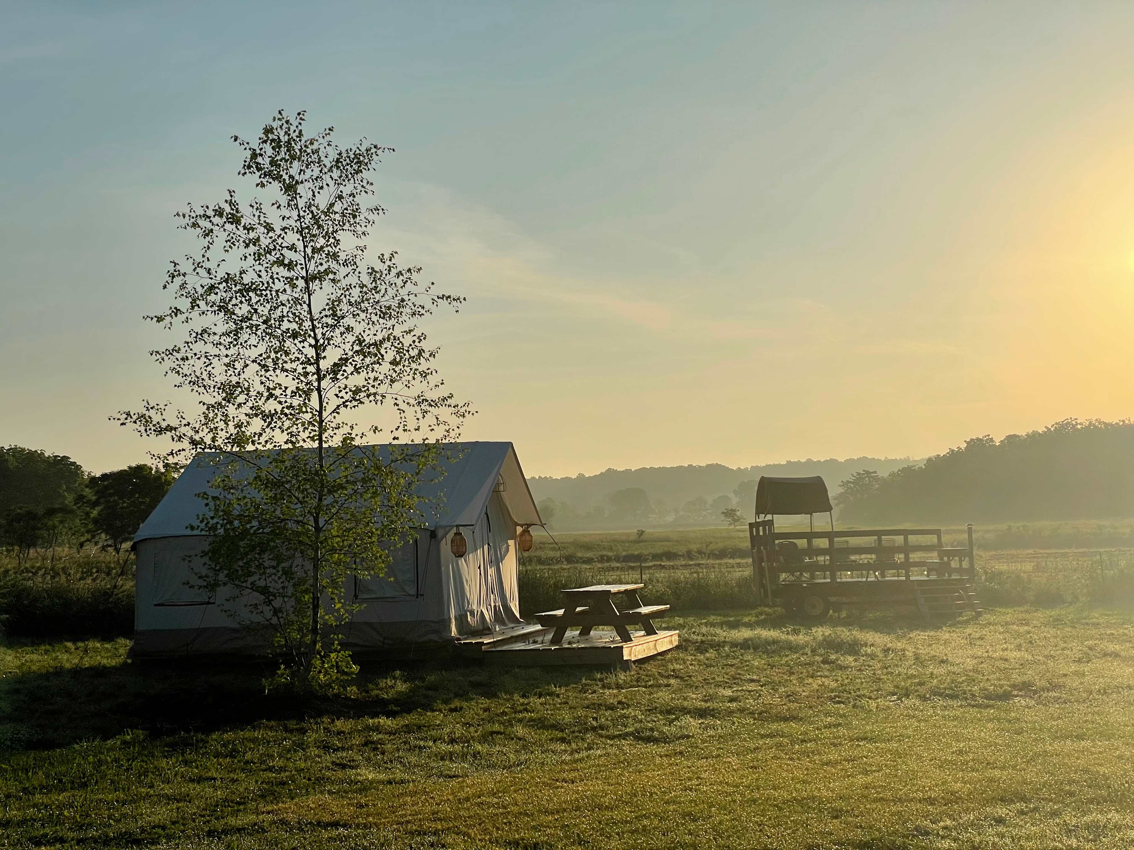 Spectacular sunrise side view of Safari Tent #2 and the communal wagon