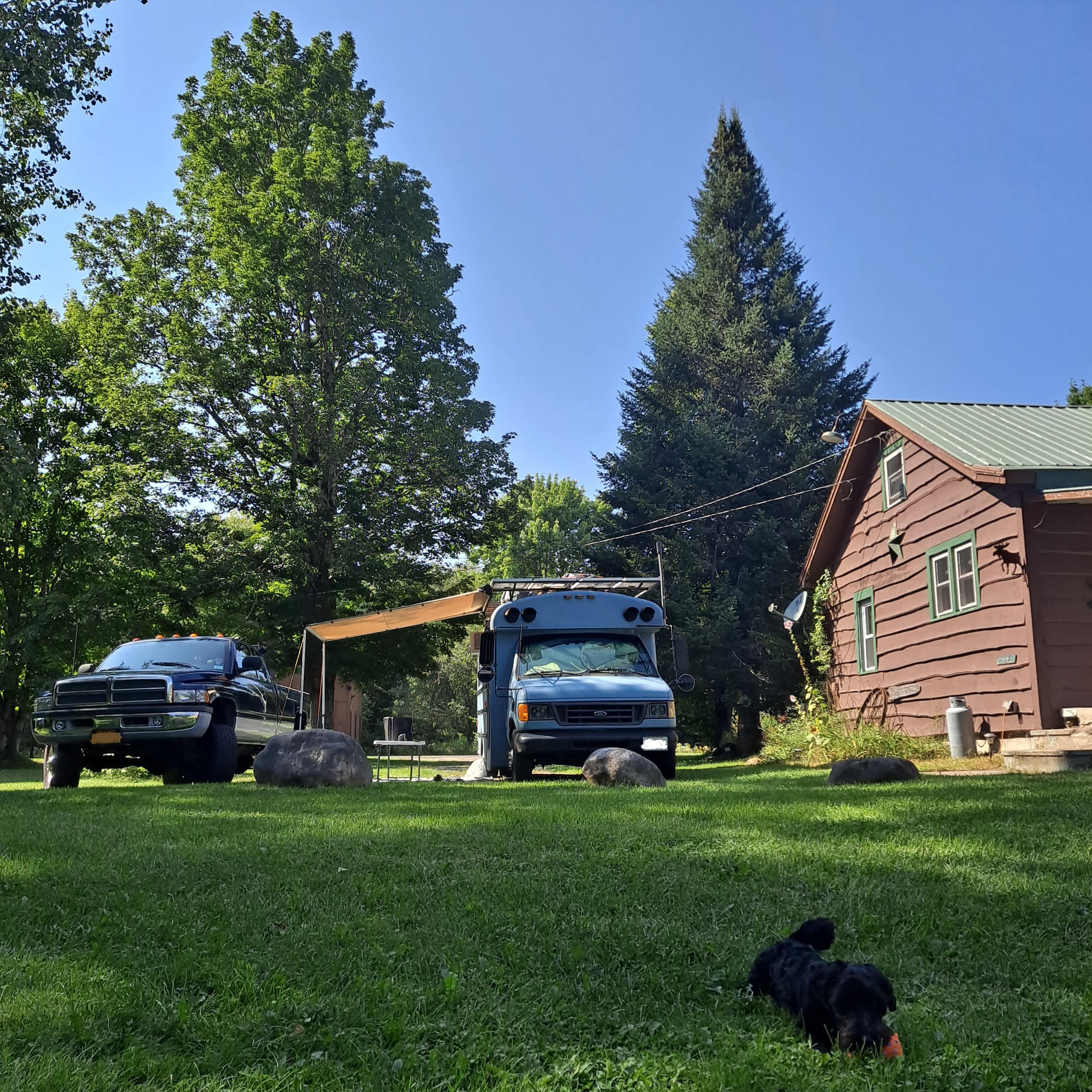 Picture taken from the firepit, 15amp on the corner of the house, spigot off picture further right.
