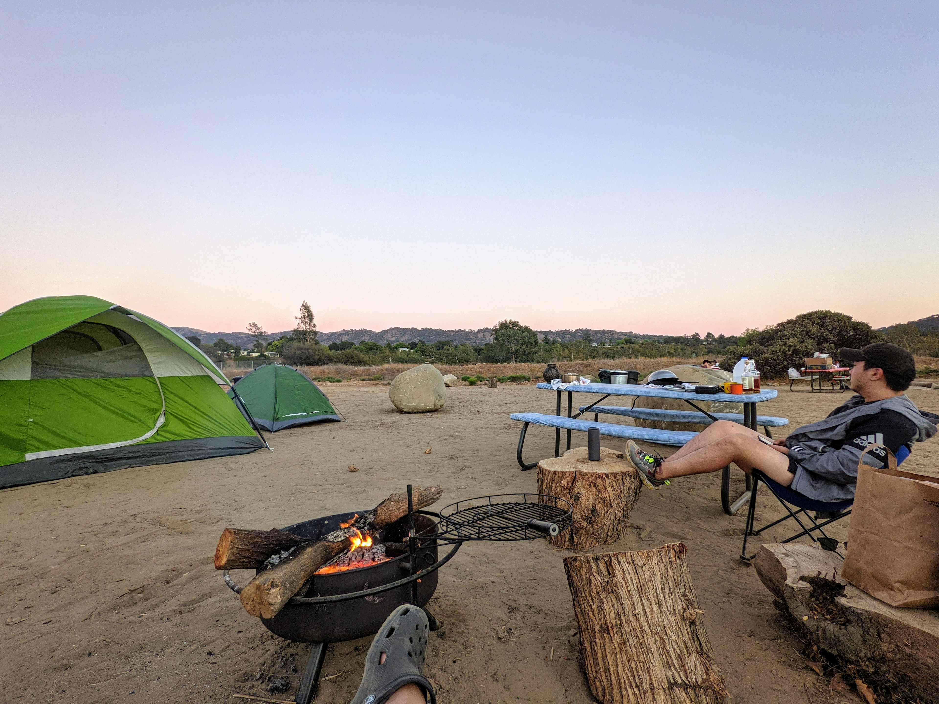 camp set up with tents and fire going.