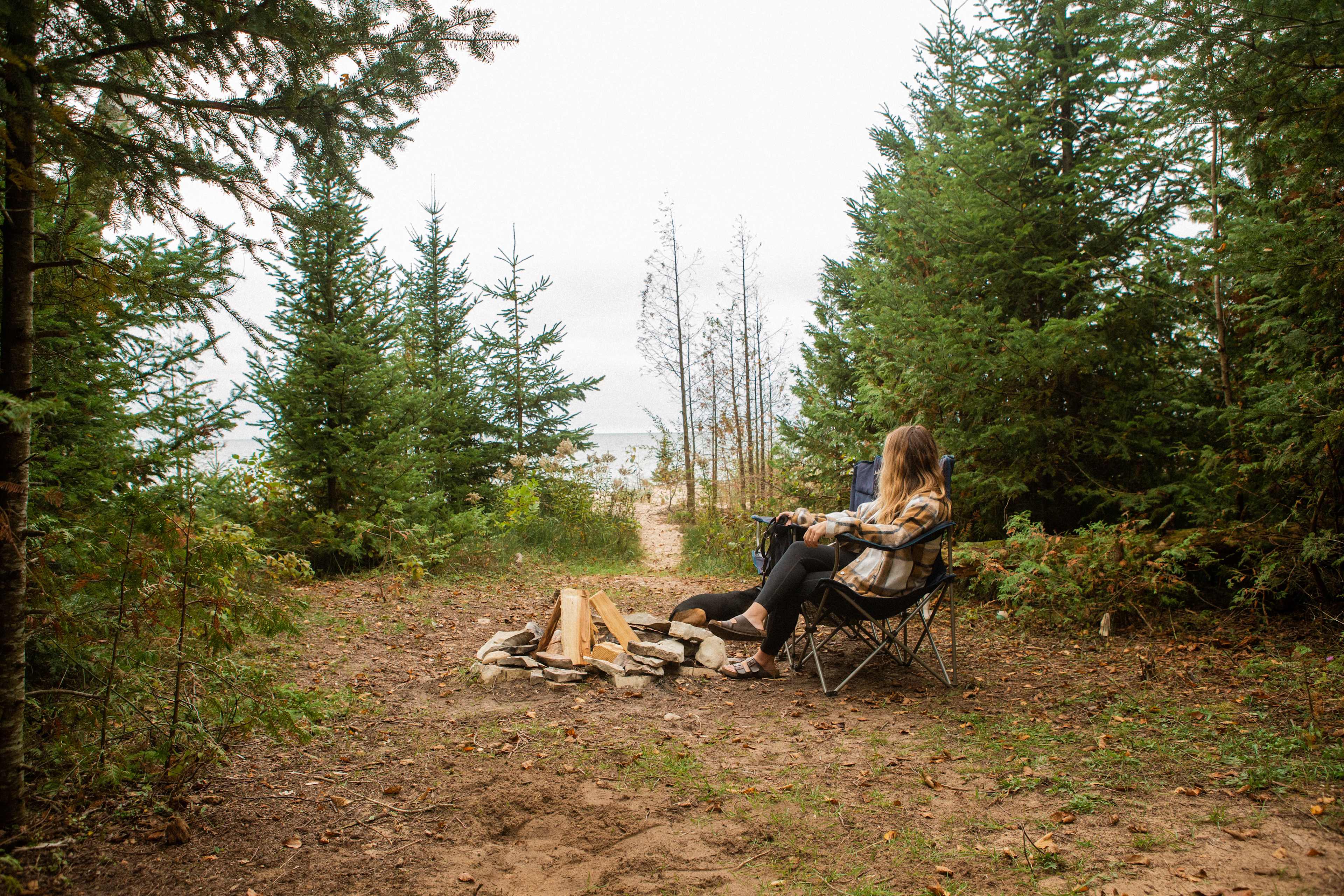 There is a clearing in between the wooded area and the beach that has a firepit and plenty of room for a tent.