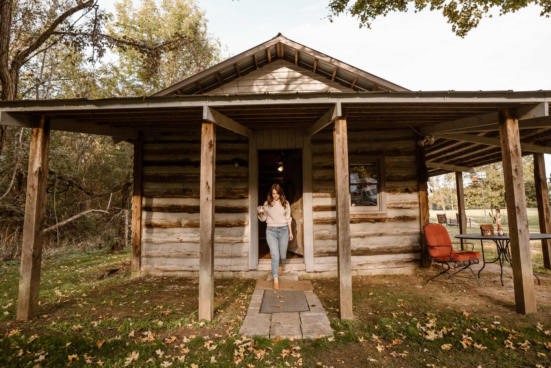 The cabin faces out onto the property and the old well house.