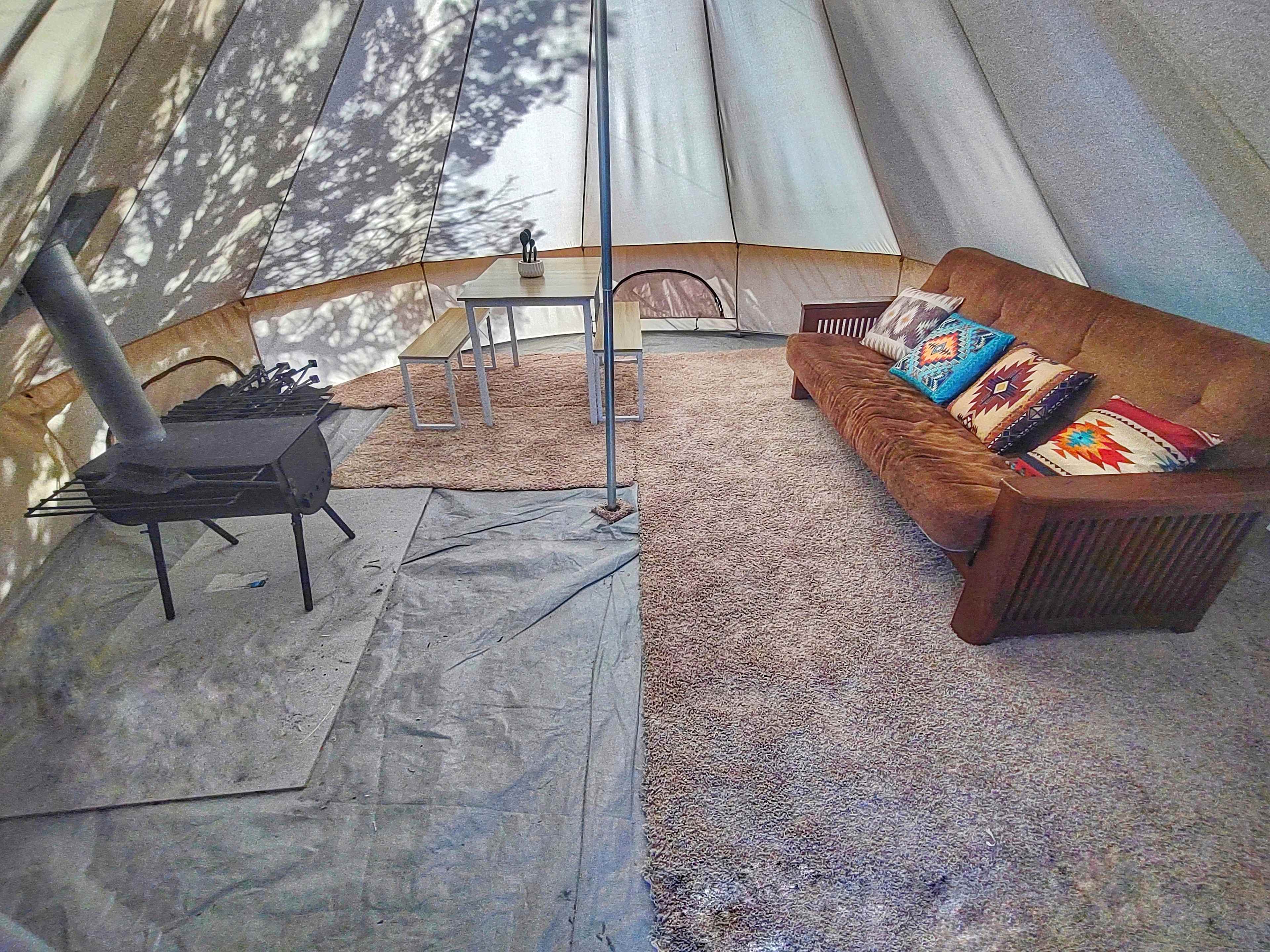Interior of tent with wood stove.
