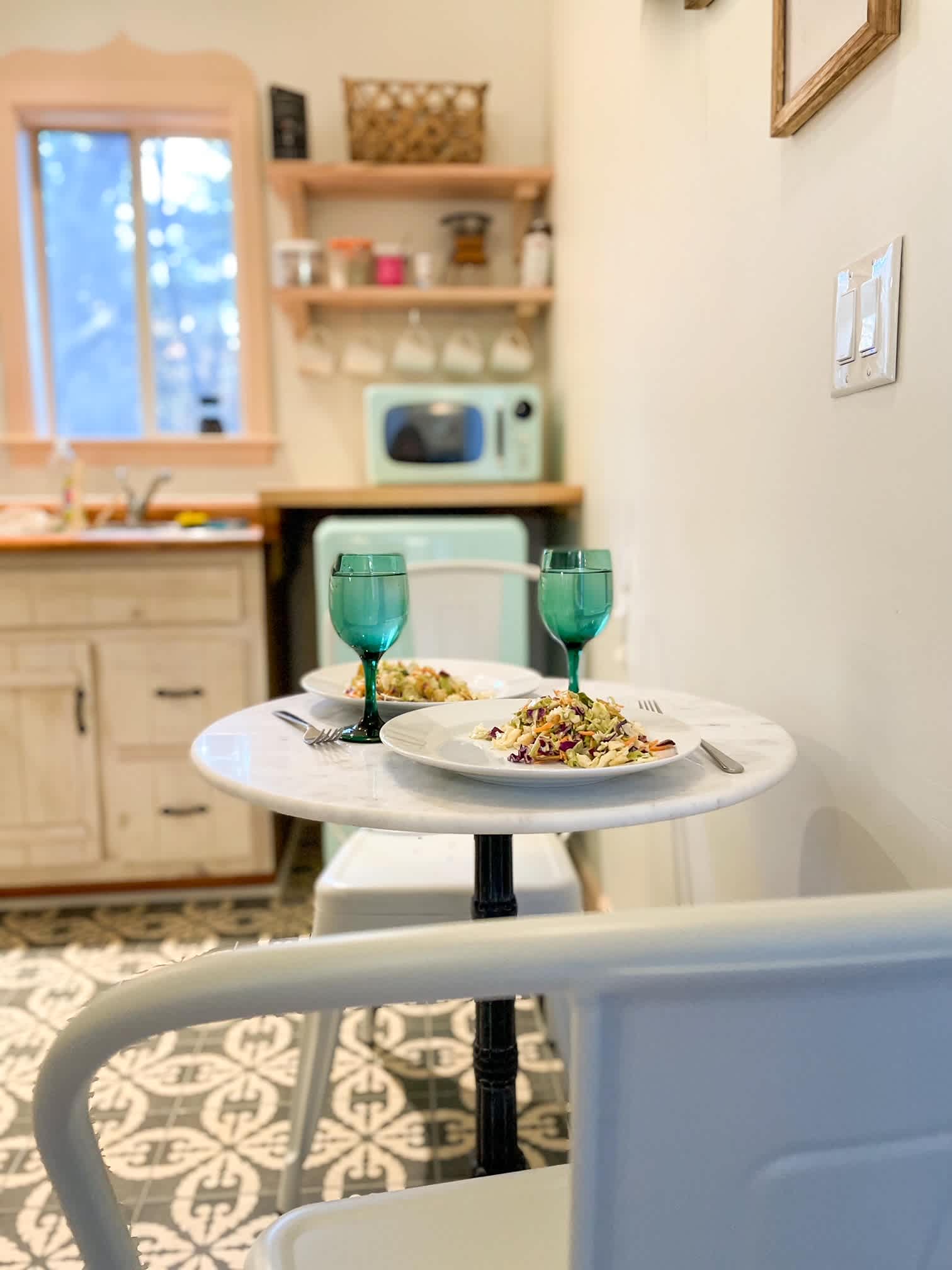 cafe table for 2. Fully equipped boho modern kitchen at Adohi Cabin in North Georgia.