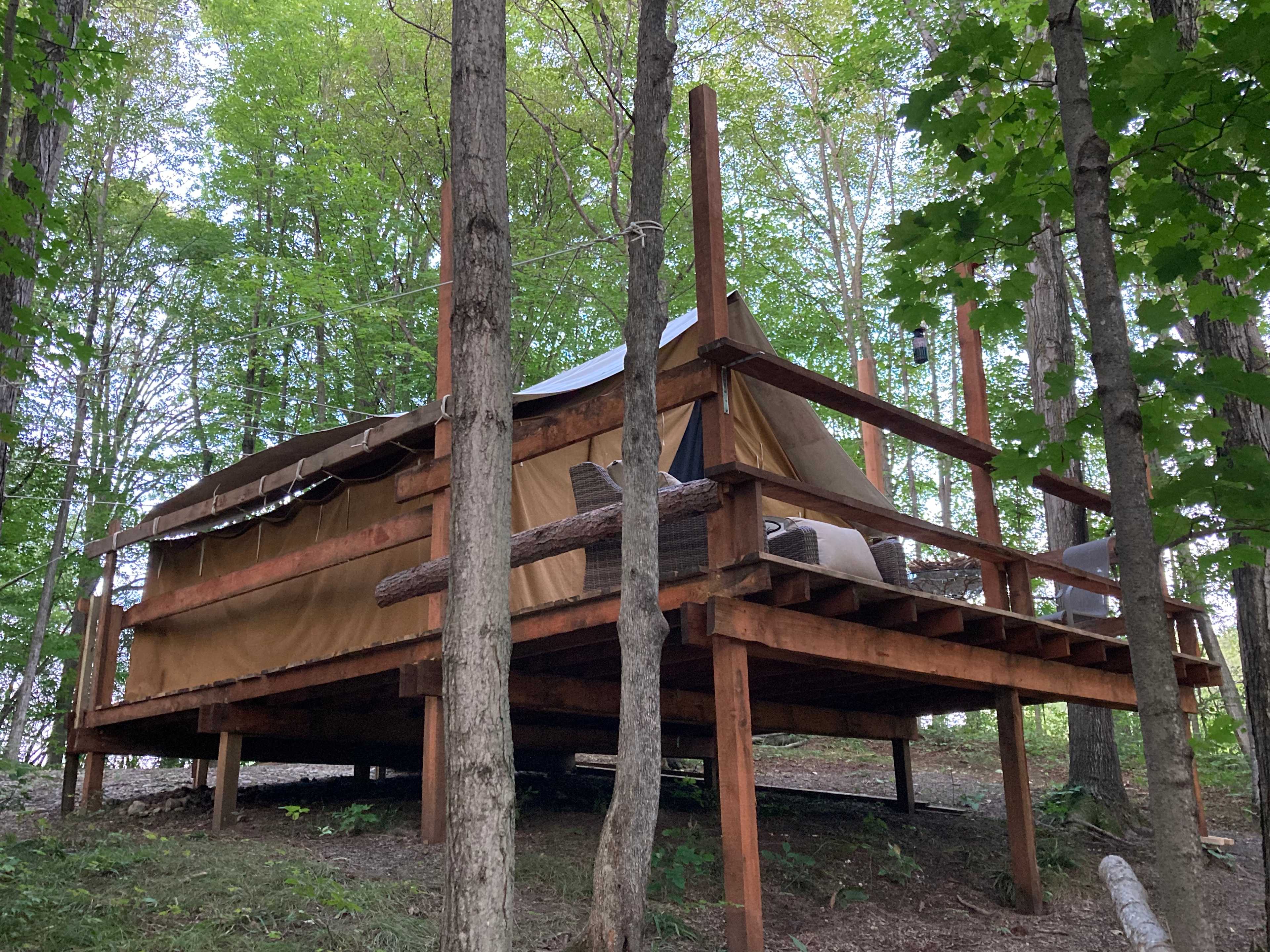 The Selah Serenity platform tent is nestled in a quiet spot in the woods. 