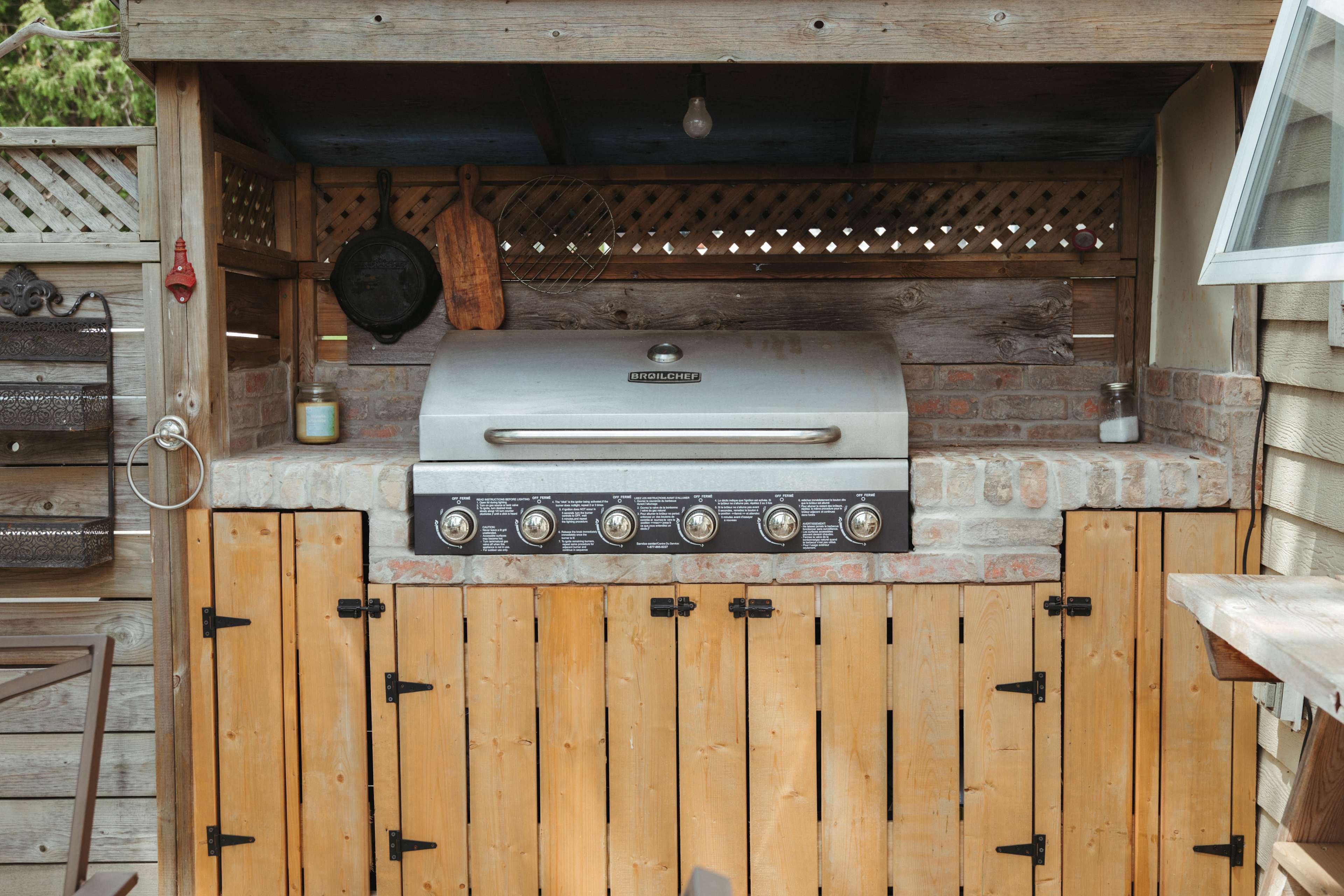 A shared patio space is equipped with a BBQ and lots of seating for the guest's use.